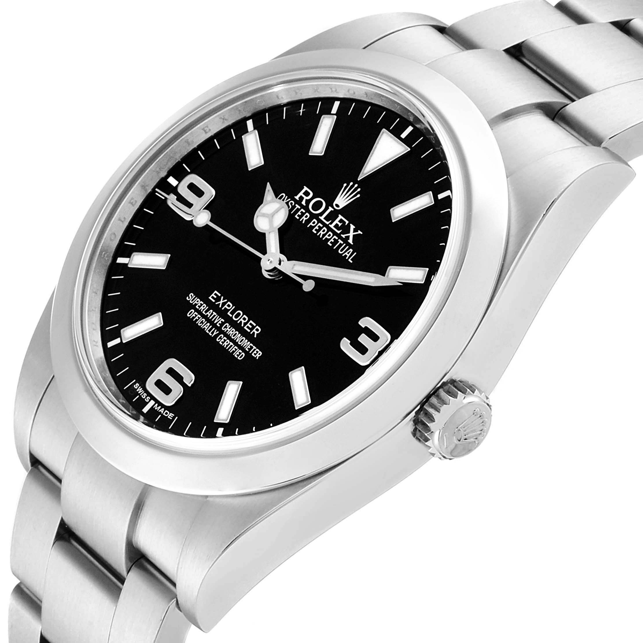 The image shows a side angle of the Rolex Explorer 214270 Men
s Stainless Steel Black Dial 214270 Men
s Stainless Steel Black Dial watch, highlighting the dial, crown, and stainless steel bracelet.