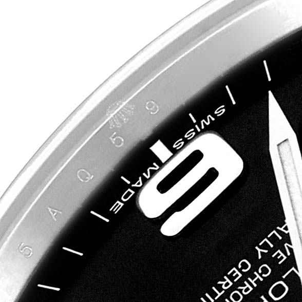 This image shows a close-up of the dial on a Rolex Explorer 214270 Men's Stainless Steel Black Dial 214270 Men's Stainless Steel Black Dial watch, featuring the number "9," "Swiss Made" text, and part of the bezel.