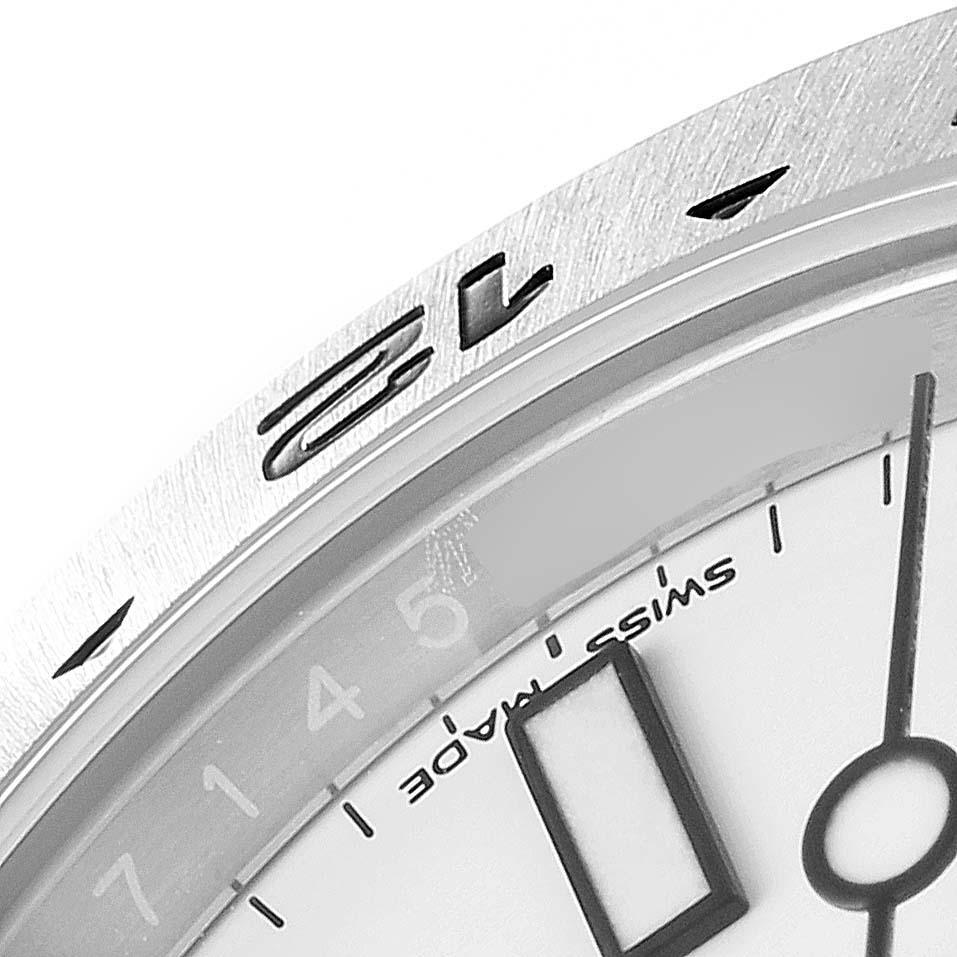 The image shows a close-up of the dial, bezel, and partial hour marker of a Rolex Explorer 216570 Men
s Stainless Steel White Dial 216570 Men
s Stainless Steel White Dial watch at an angle.
