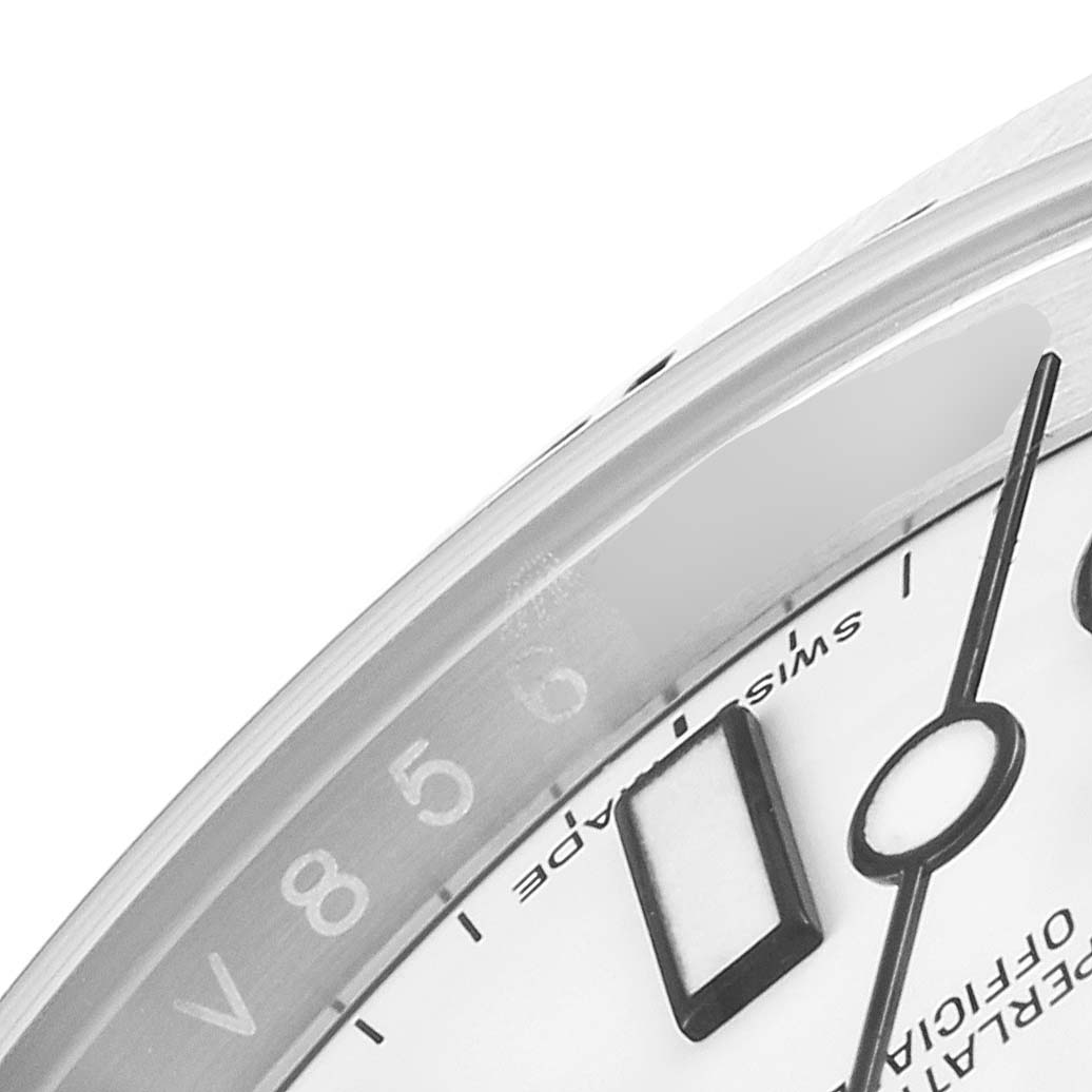The image shows a close-up of the dial and bezel of a Rolex Explorer 216570 Men
s Stainless Steel White Dial 216570 Men
s Stainless Steel White Dial watch, highlighting the minute markers and part of the hands.