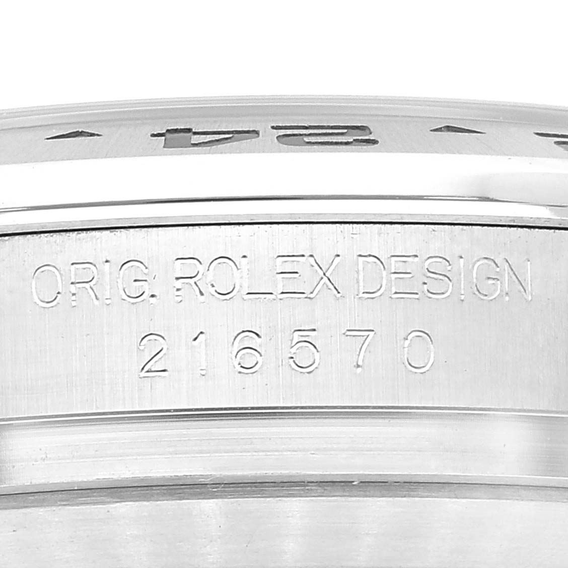 The image shows a close-up of the case side of the Rolex Explorer 216570 Men
s Stainless Steel Black Dial 216570 Men
s Stainless Steel Black Dial, displaying the engraving "ORIG. ROLEX DESIGN 216570".