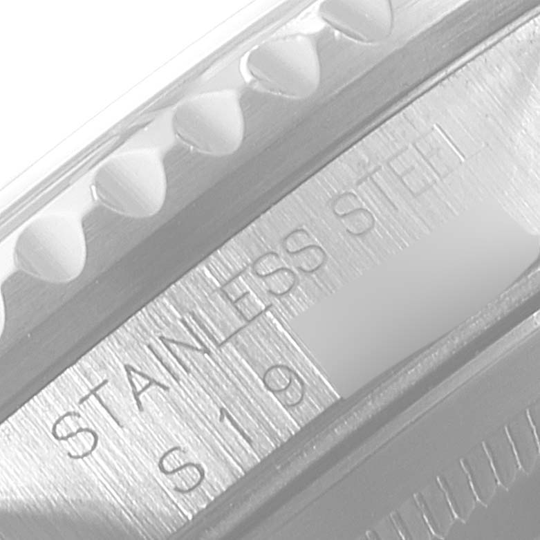 The image shows a close-up of the Rolex GMT-Master 16700 Men
s Stainless Steel Black Dial 16700 Men
s Stainless Steel Black Dial watch, focusing on the "Stainless Steel" engraving and part of the bezel.