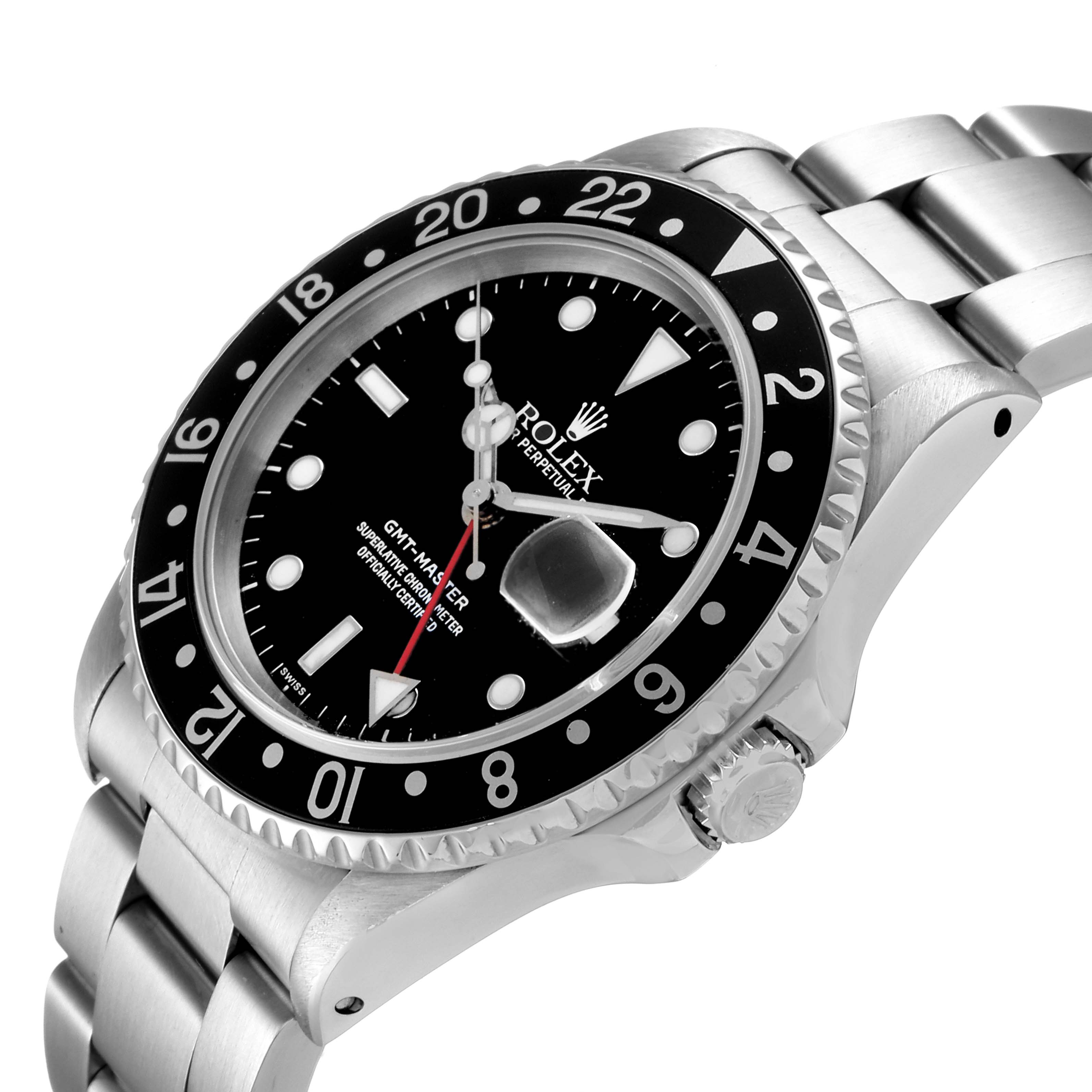 The image shows a Rolex GMT-Master 16700 Men
s Stainless Steel Black Dial 16700 Men
s Stainless Steel Black Dial watch at an angled top-down view, highlighting the bezel, dial, crown, and bracelet.