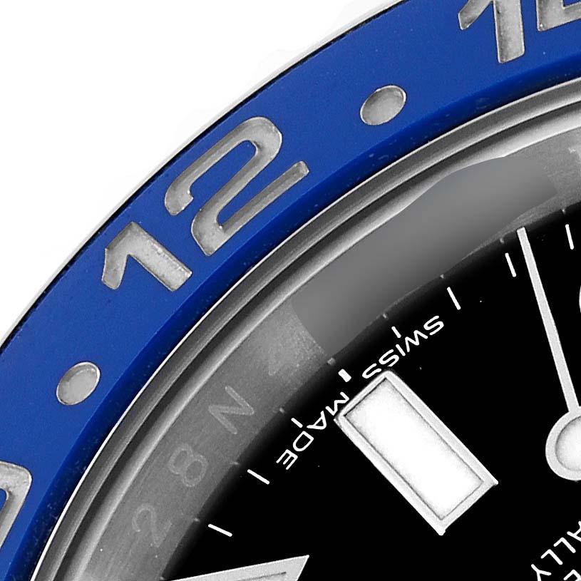 This close-up image shows the bezel, dial, and part of the 12 o'clock marker of the Rolex GMT-Master 116710BLNR Men's Stainless Steel Black Dial 116710BLNR Men's Stainless Steel Black Dial watch.