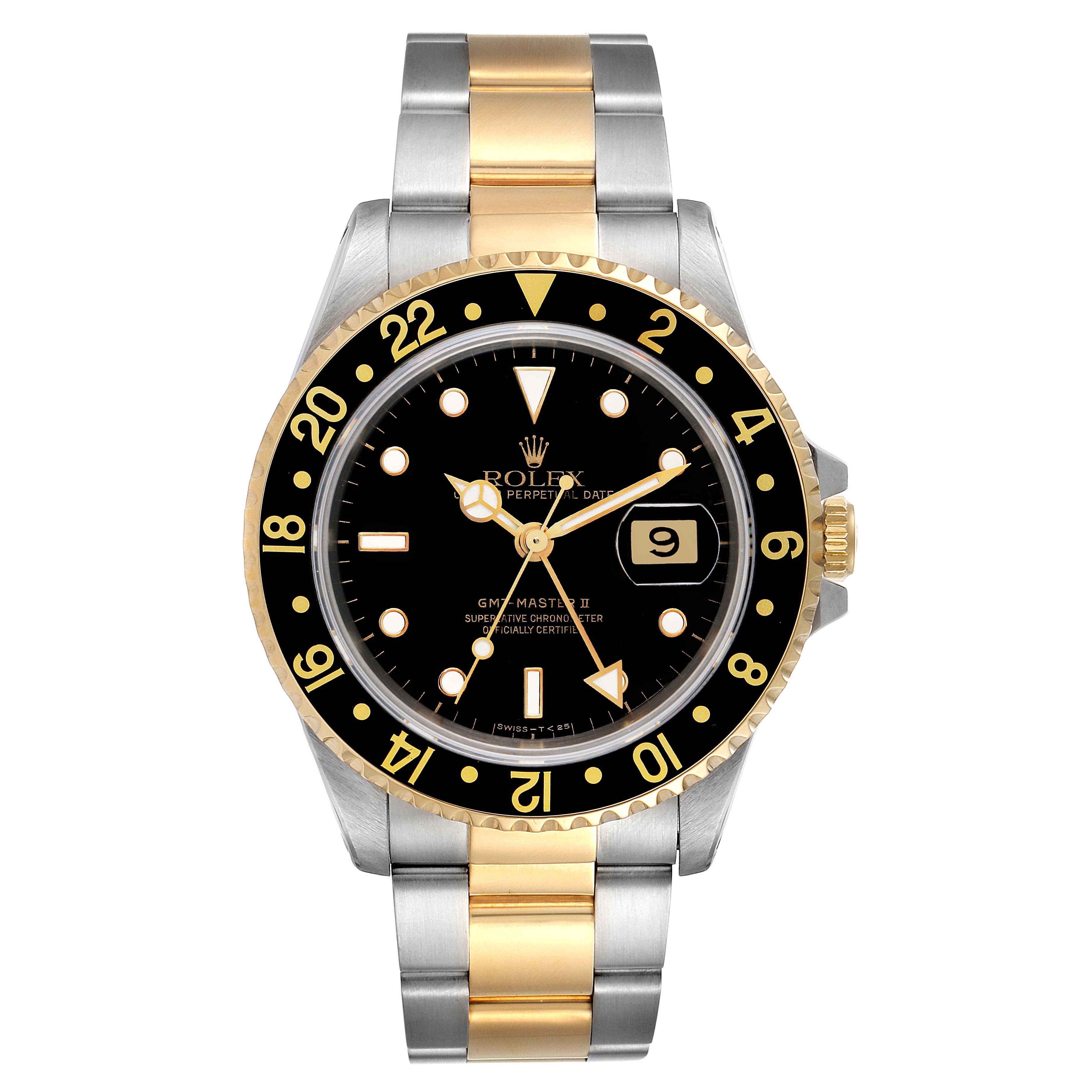 The Rolex GMT-Master 16713 Men's Steel and Gold (two tone) Black Dial 16713 Men's Steel and Gold (two tone) Black Dial watch is shown from a front angle, displaying its black dial, date, two-tone bezel, and bracelet.