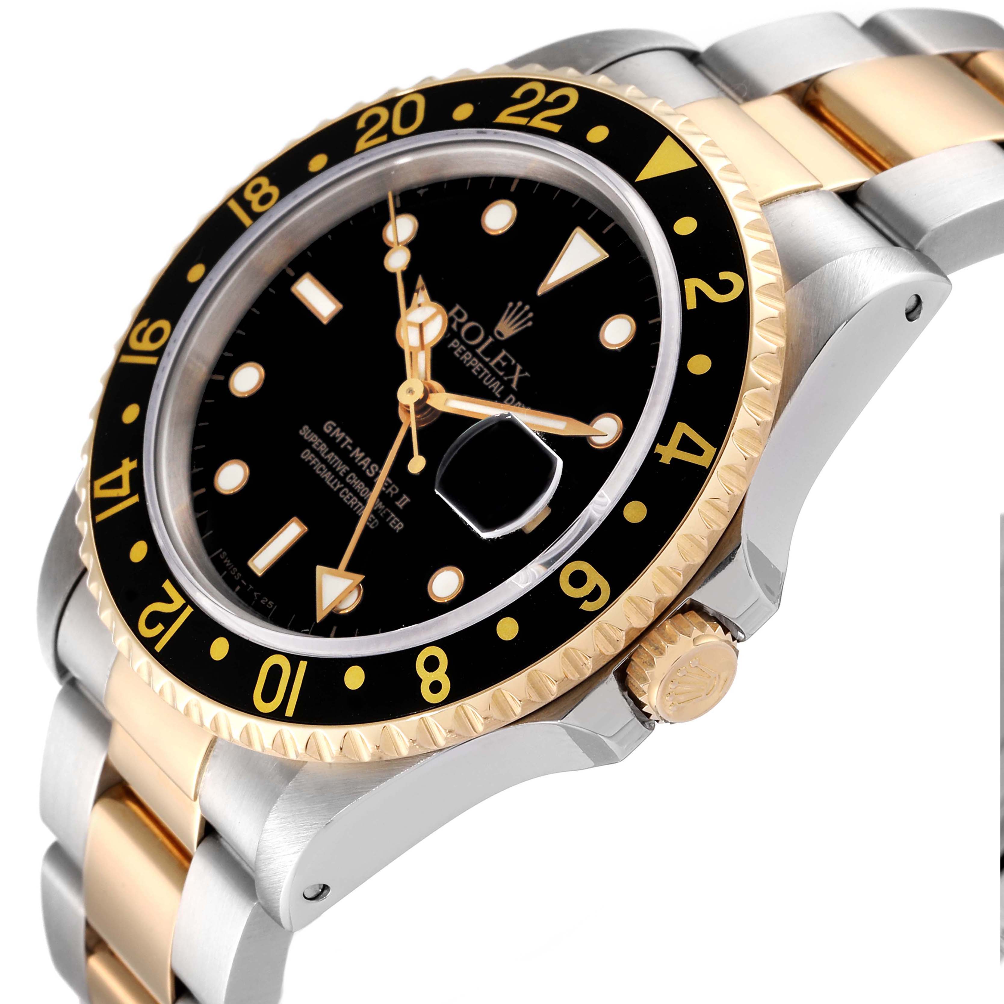 The image shows a side angle of a Rolex GMT-Master 16713 Men's Steel and Gold (two tone) Black Dial 16713 Men's Steel and Gold (two tone) Black Dial watch, highlighting its bezel, dial, crown, and metal bracelet.