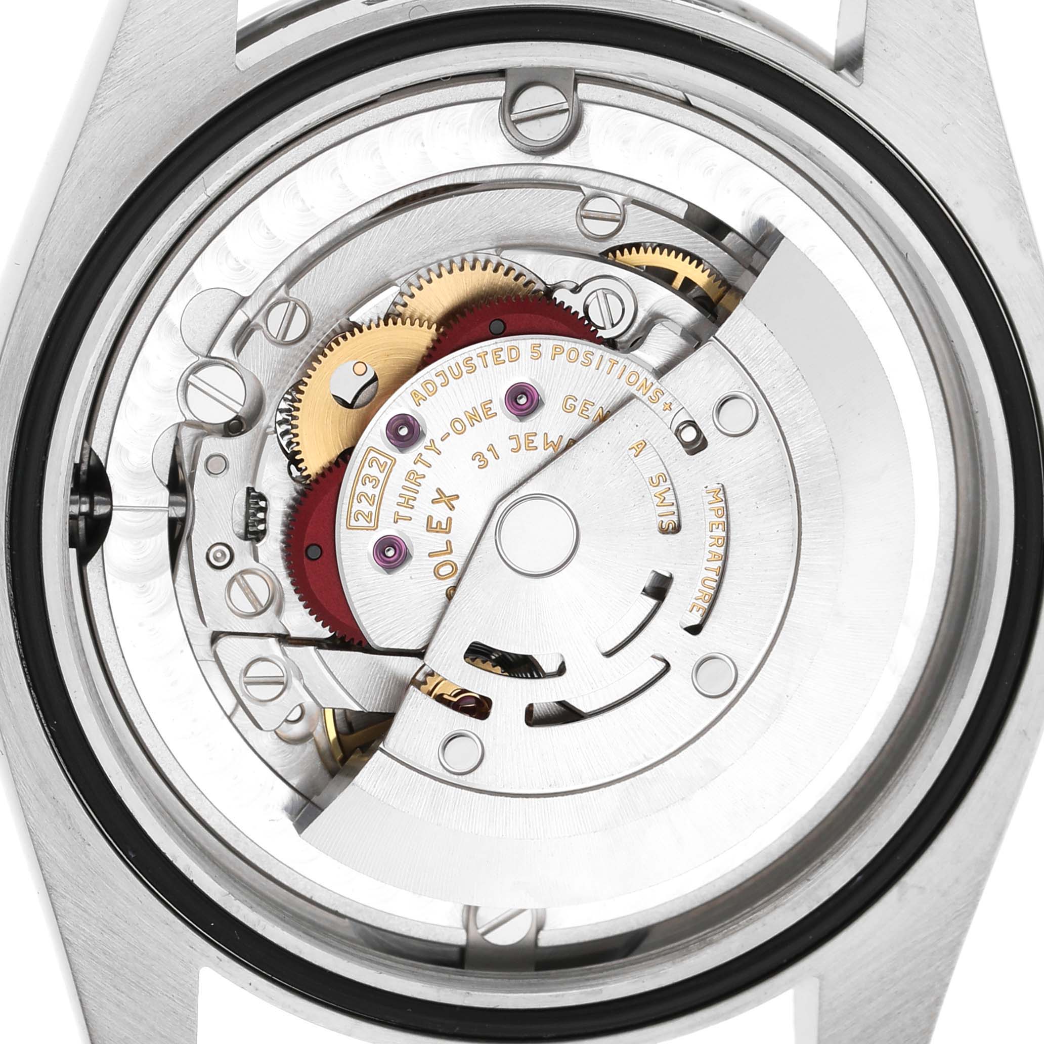 The Rolex Oyster Perpetual 124200 Men's Stainless Steel Blue Dial is shown from a back angle, revealing its intricate internal movement and components.