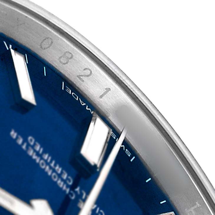 The image shows a close-up of the Rolex Oyster Perpetual 124200 Men's Stainless Steel Blue Dial's dial, focusing on the edge of the blue face and part of the bezel with engraved numbers.
