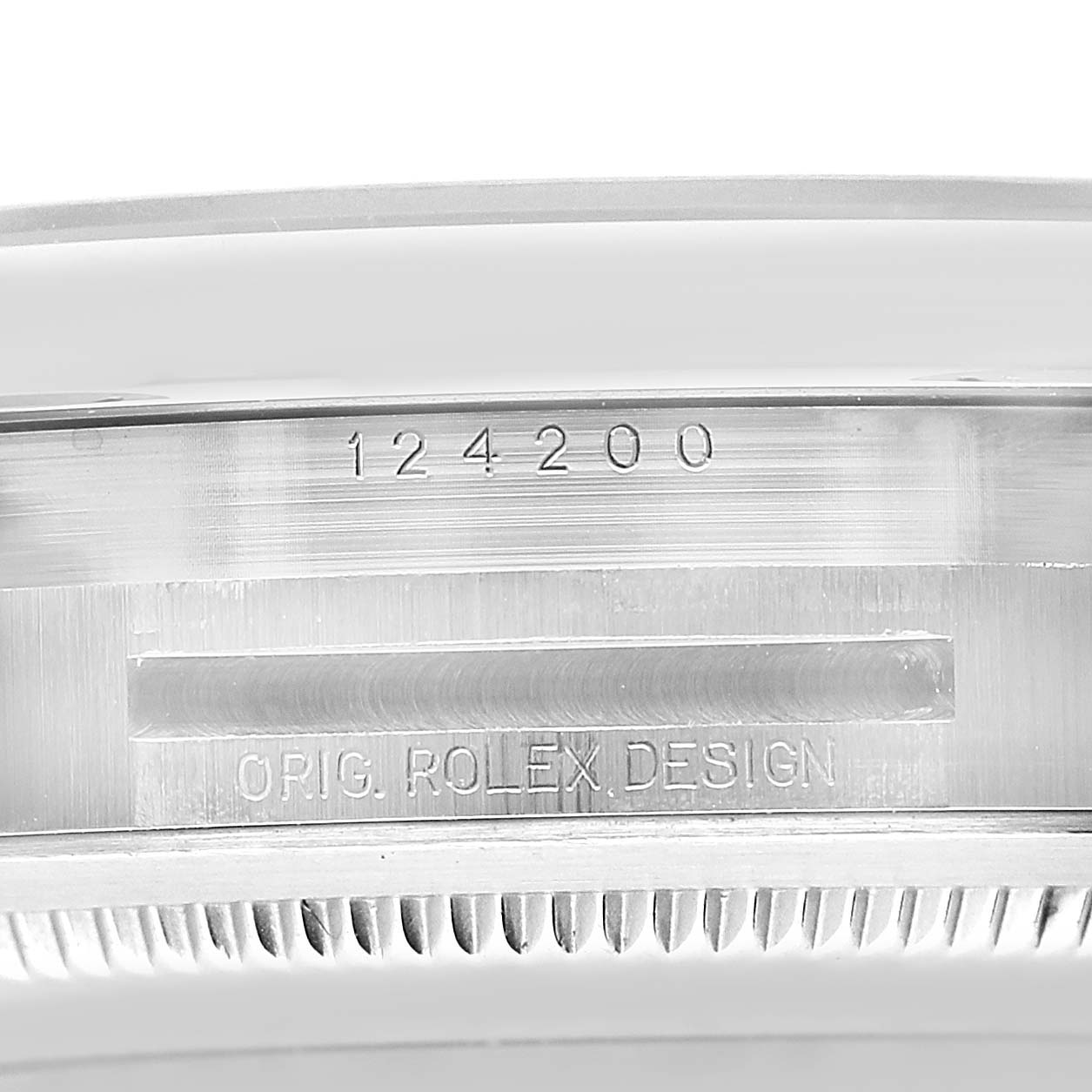 The image shows a close-up side view of the Rolex Oyster Perpetual 124200 Men's Stainless Steel Blue Dial watch case, featuring the engraved serial and design numbers.