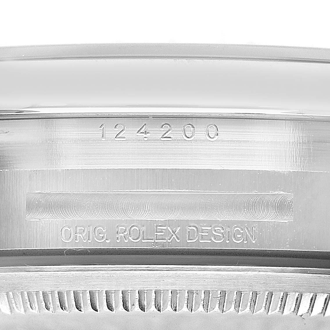 The image shows the side of the Rolex Oyster Perpetual 124200 Women's Stainless Steel Pink Dial case, featuring engraved model numbers and "ORIG. ROLEX DESIGN."