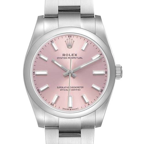 The Oyster Perpetual by Rolex is shown from the front, focusing on the pink dial, hands, and part of the bracelet.
