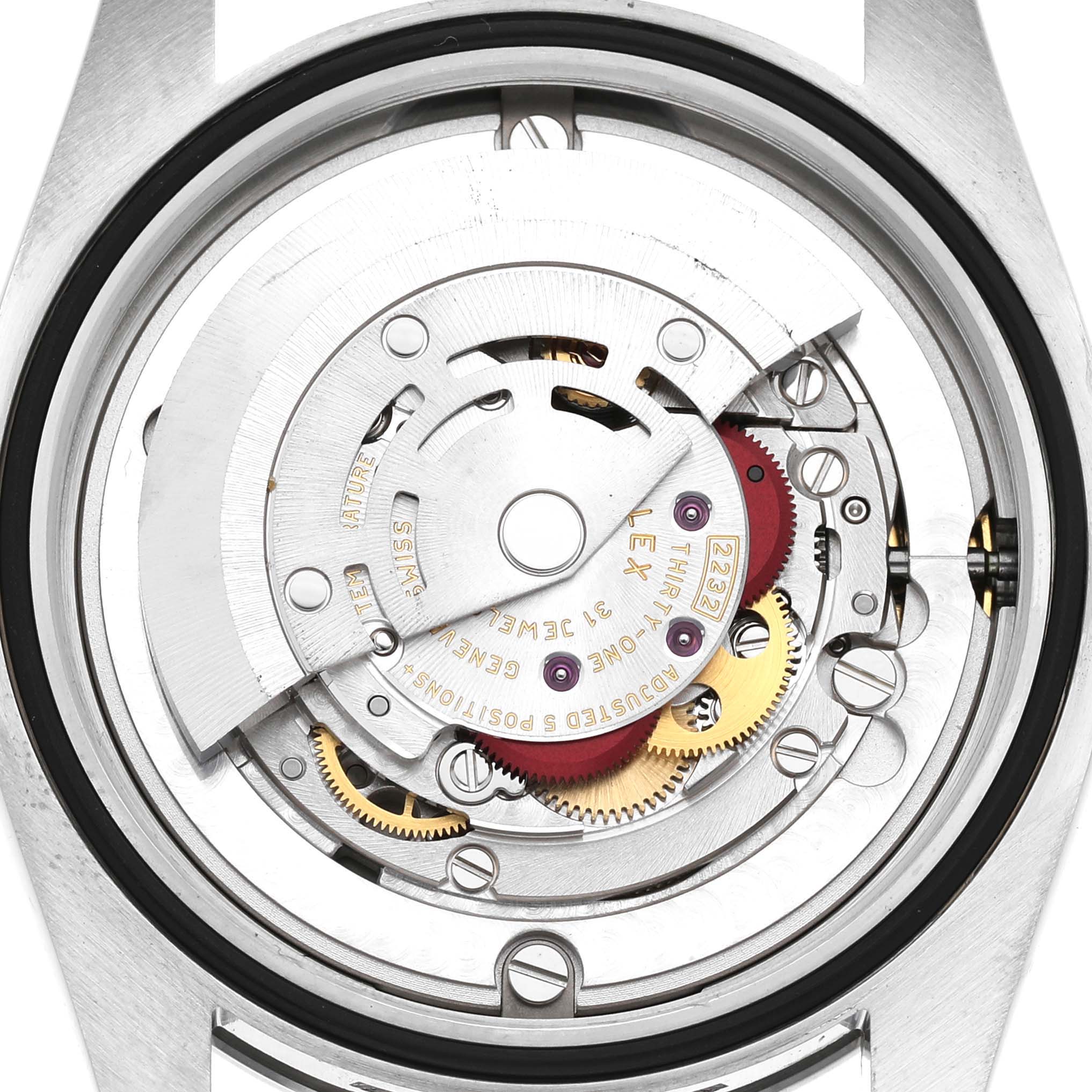The image shows the movement mechanism from a rear angle of the Rolex Oyster Perpetual 124200 Women's Stainless Steel Pink Dial watch, highlighting gears and components.