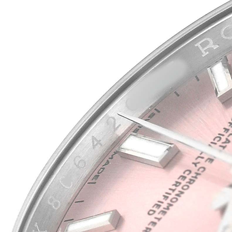 The image shows a close-up of the dial and bezel of a Rolex Oyster Perpetual 124200 Women's Stainless Steel Pink Dial watch, highlighting the pink dial and silver indices.