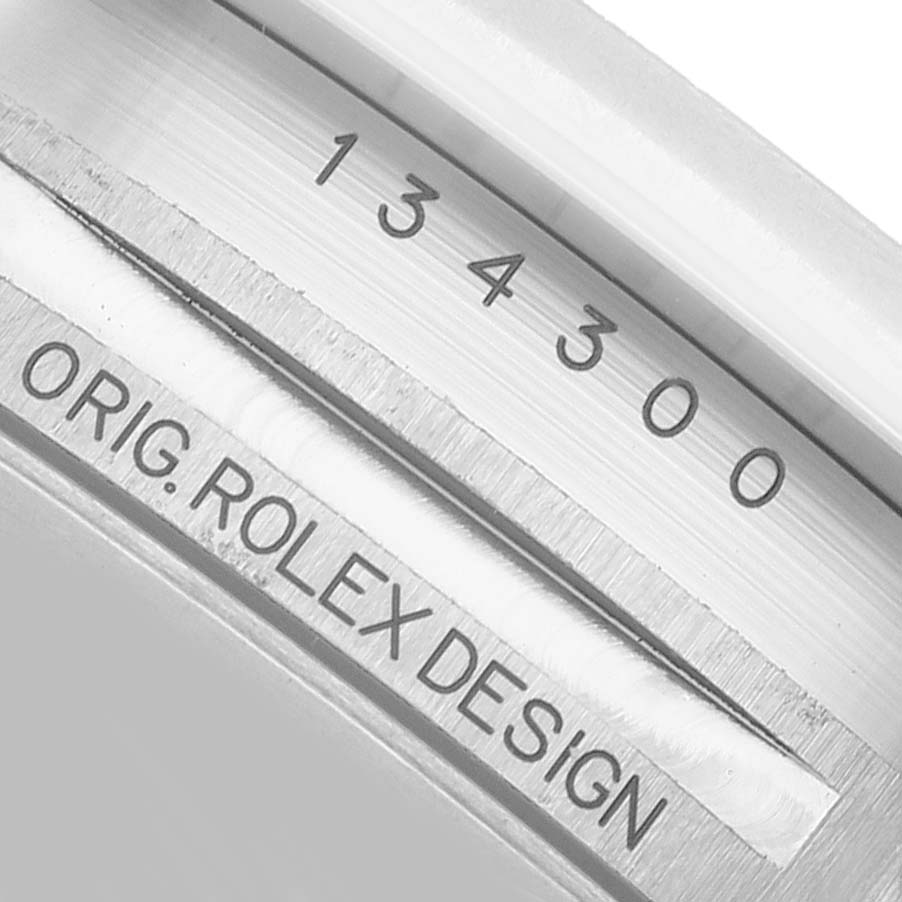 The image shows an engraved part of the Oyster Perpetual by Rolex, displaying the serial and design numbers.