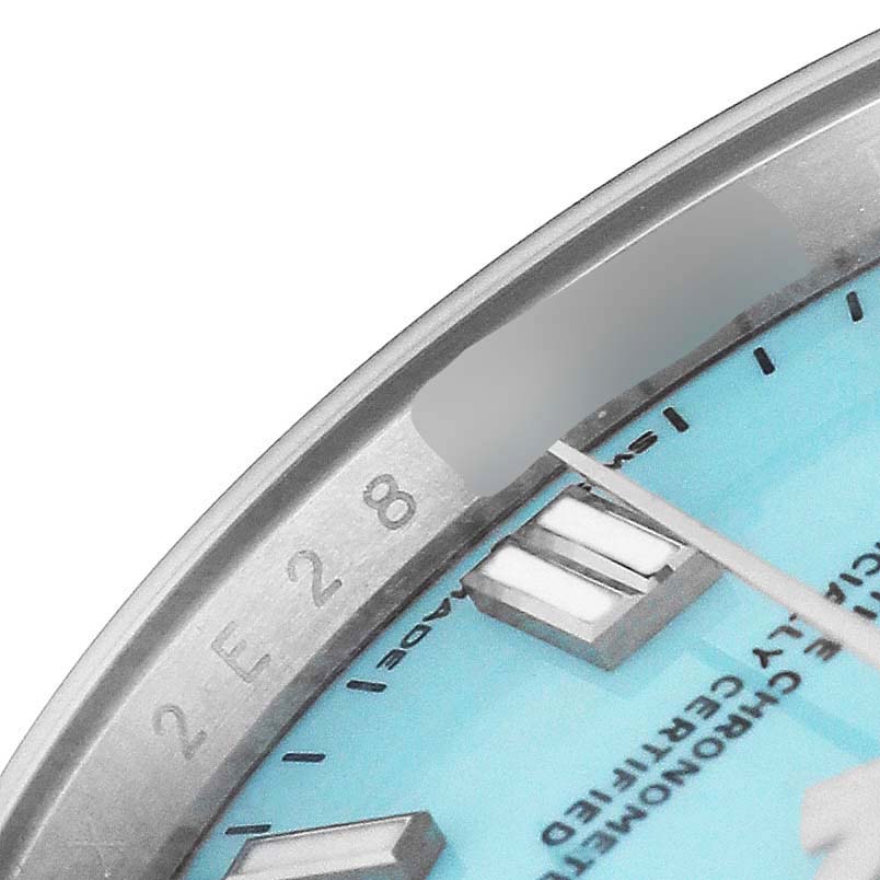 The image shows a close-up of the dial, indices, and part of the bezel of the Rolex Oyster Perpetual 126000 Men's Stainless Steel Blue Dial watch.