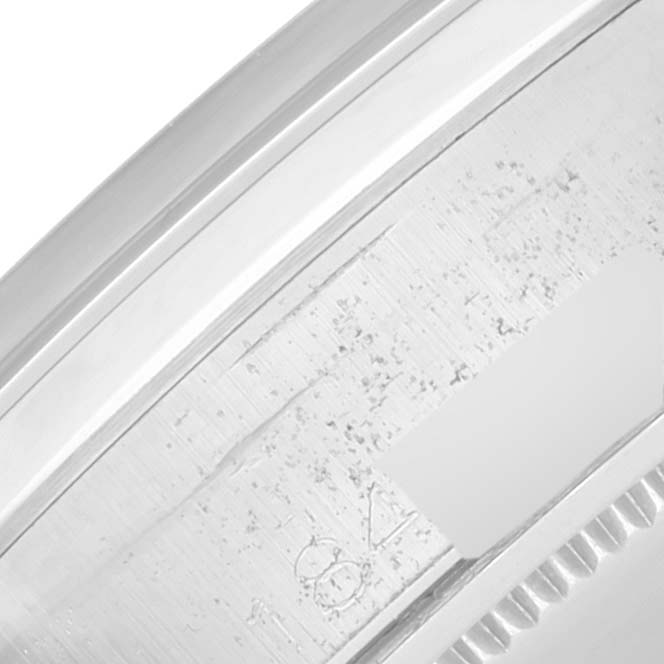 This image shows a close-up of the serial number engraved on the side of the case of a Vintage Collection Rolex watch.