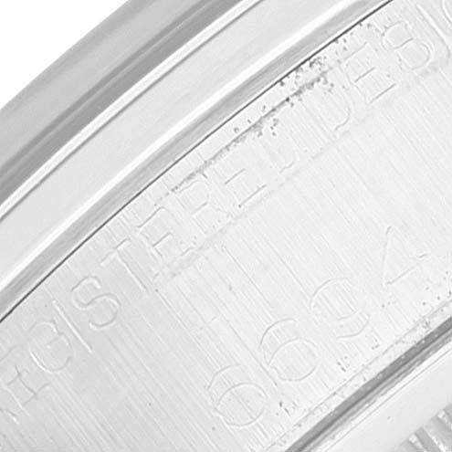 This image shows a close-up view of the engraved outer edge of the case of a Rolex Vintage Collection 6694 Men's Stainless Steel Silver Dial 6694 Men's Stainless Steel Silver Dial watch.