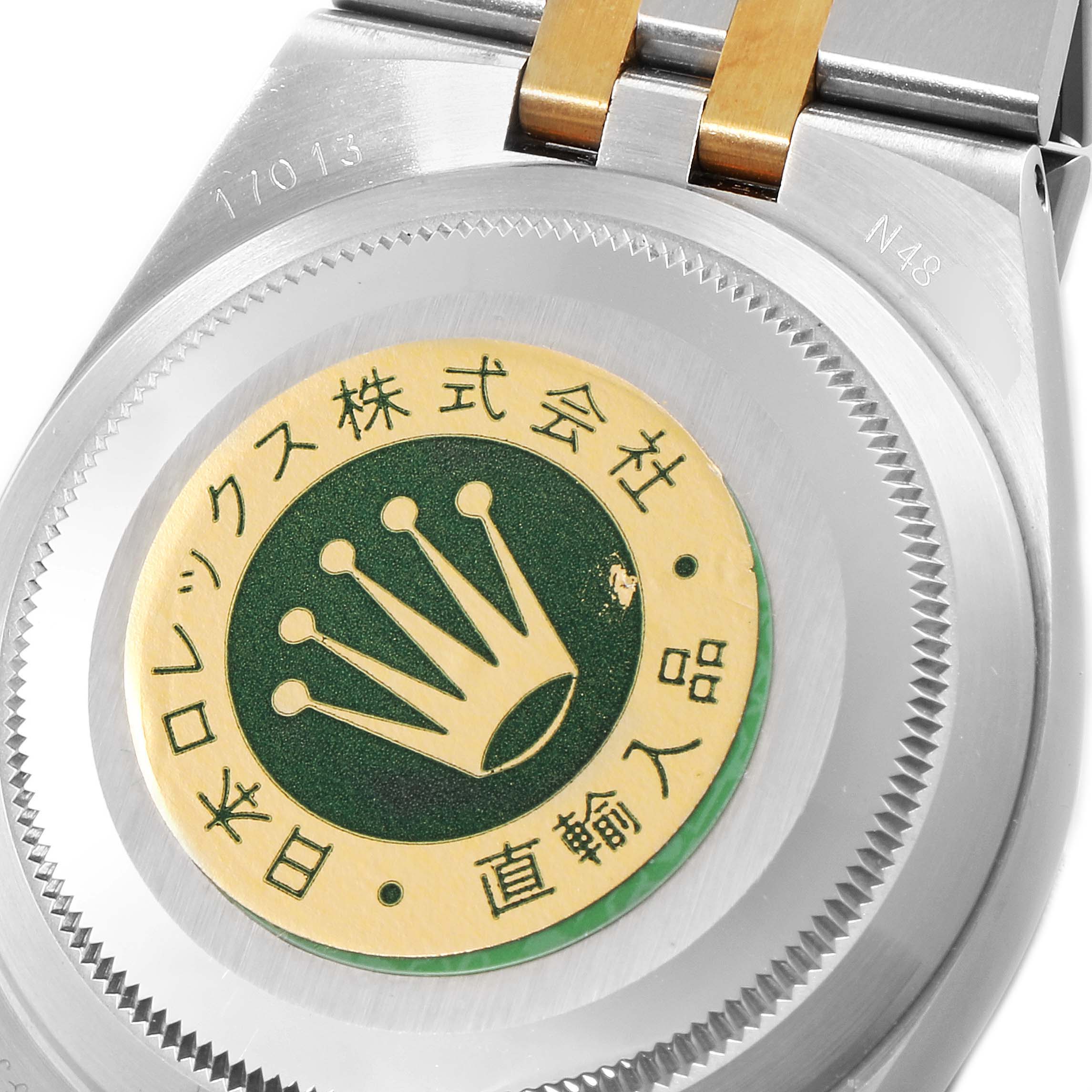 The image shows the back case of a Rolex Oysterquartz 17013 Men's Steel and Gold (two tone) Champagne Dial 17013 Men's Steel and Gold (two tone) Champagne Dial watch, highlighting the sticker and part of the bracelet.