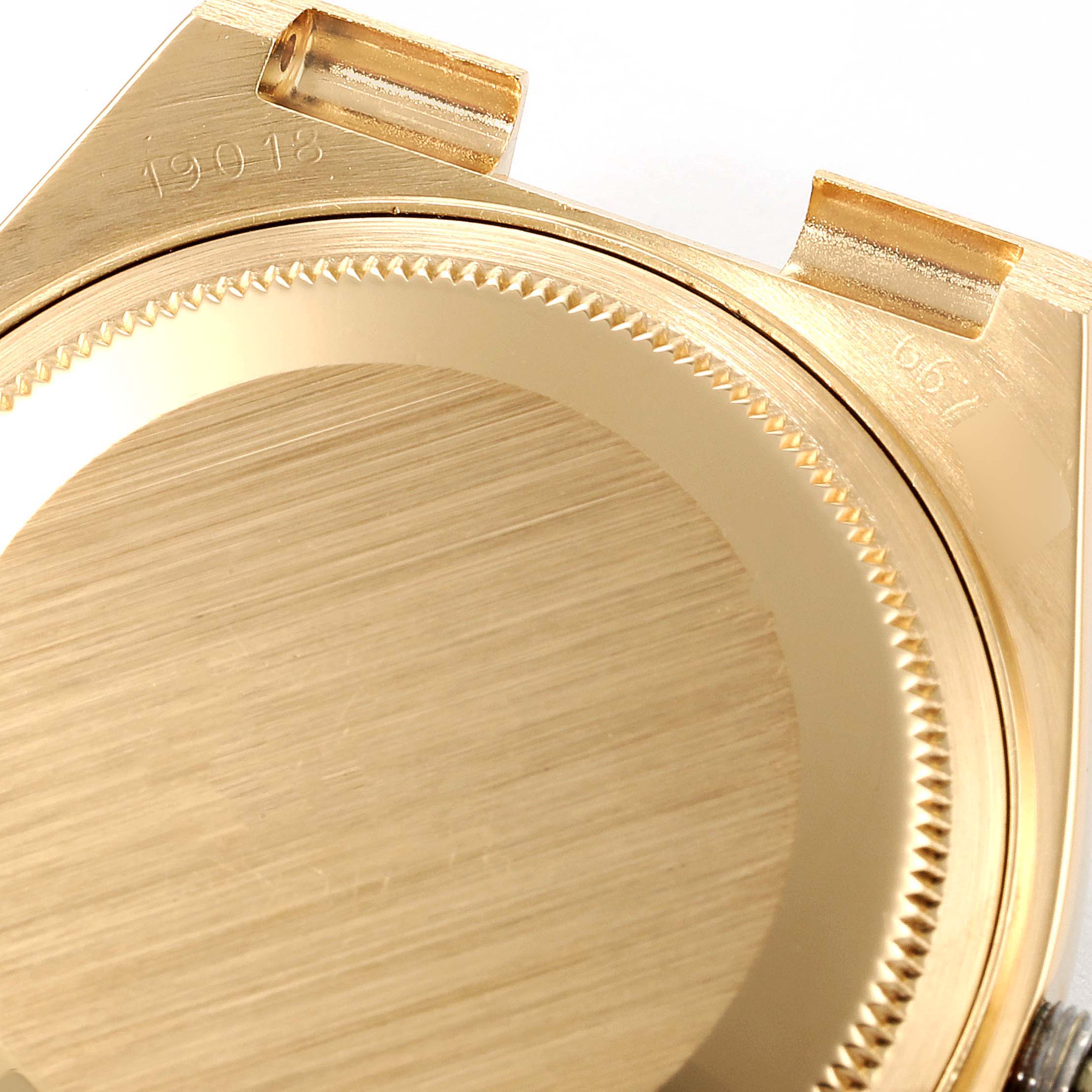 The image shows the back and sides of the Rolex Oysterquartz 19018 Men
s Yellow Gold Champagne Dial 19018 Men
s Yellow Gold Champagne Dial watch case, highlighting its brushed gold texture and engravings.
