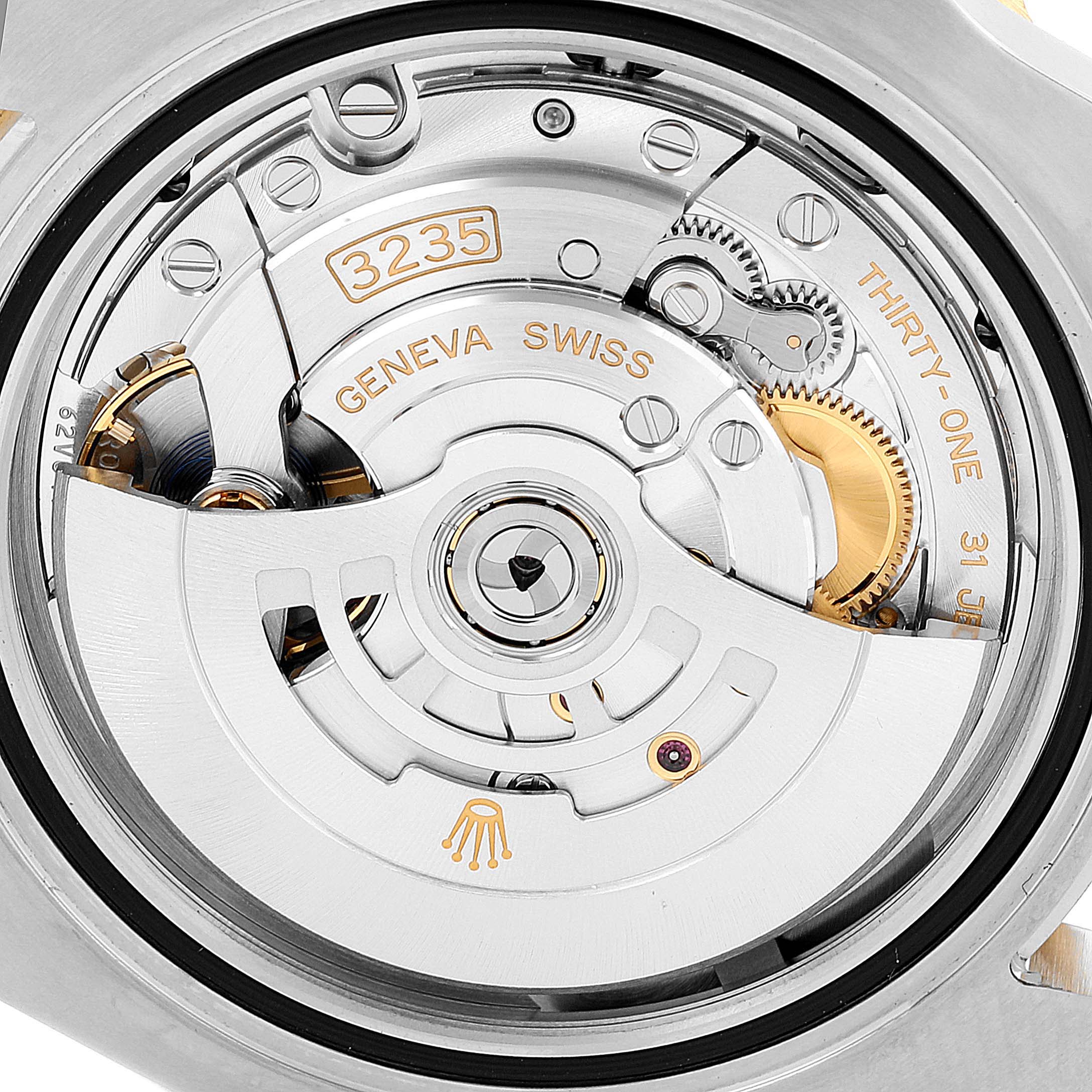 This image shows the interior movement mechanism of a Rolex Submariner 126613 Men
s Steel and Gold (two tone) Blue Dial 126613 Men
s Steel and Gold (two tone) Blue Dial, highlighting the intricate gears and the "3235" marking.