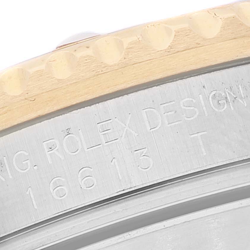 This close-up image shows the edge of the bezel and the engraved case details of a Rolex Submariner 16613 Men's Steel and Gold (two tone) Blue Dial 16613 Men's Steel and Gold (two tone) Blue Dial model 16613.