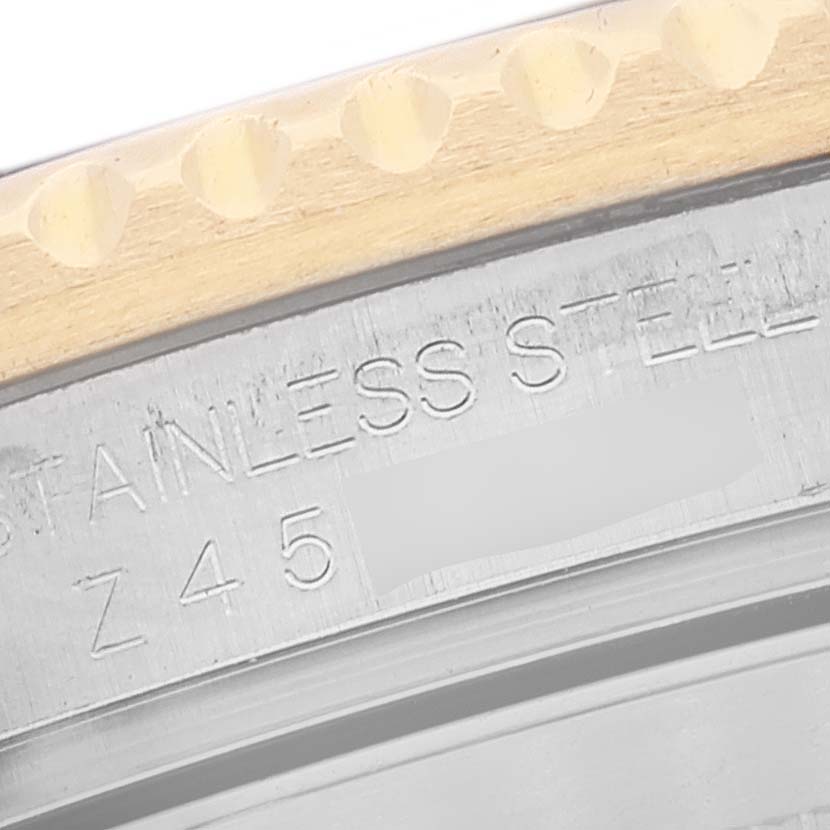 This close-up image shows the bezel and engraved edge of the Rolex Submariner 16613 Men's Steel and Gold (two tone) Blue Dial 16613 Men's Steel and Gold (two tone) Blue Dial watch.