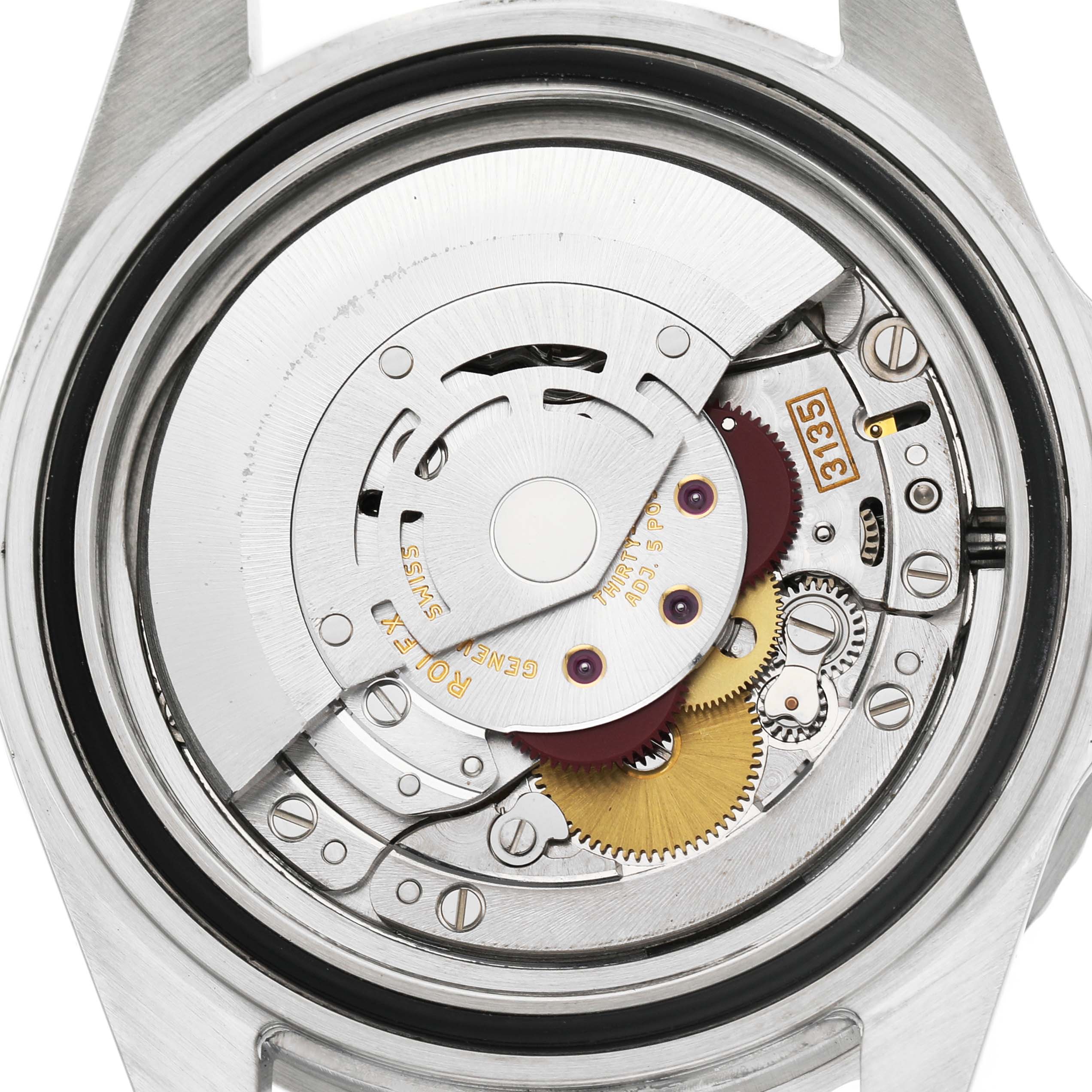 The image shows the movement of a Rolex Submariner 16610 Men's Stainless Steel Black Dial watch from a rear angle, highlighting its intricate mechanical components.