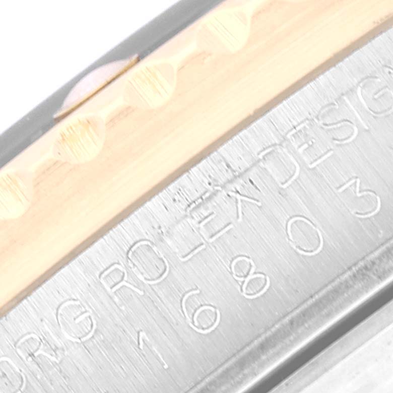 This close-up image shows the engraved details on the bezel and casing of a Rolex Submariner 16803 Men's Steel and Gold (two tone) Black Dial 16803 Men's Steel and Gold (two tone) Black Dial watch.