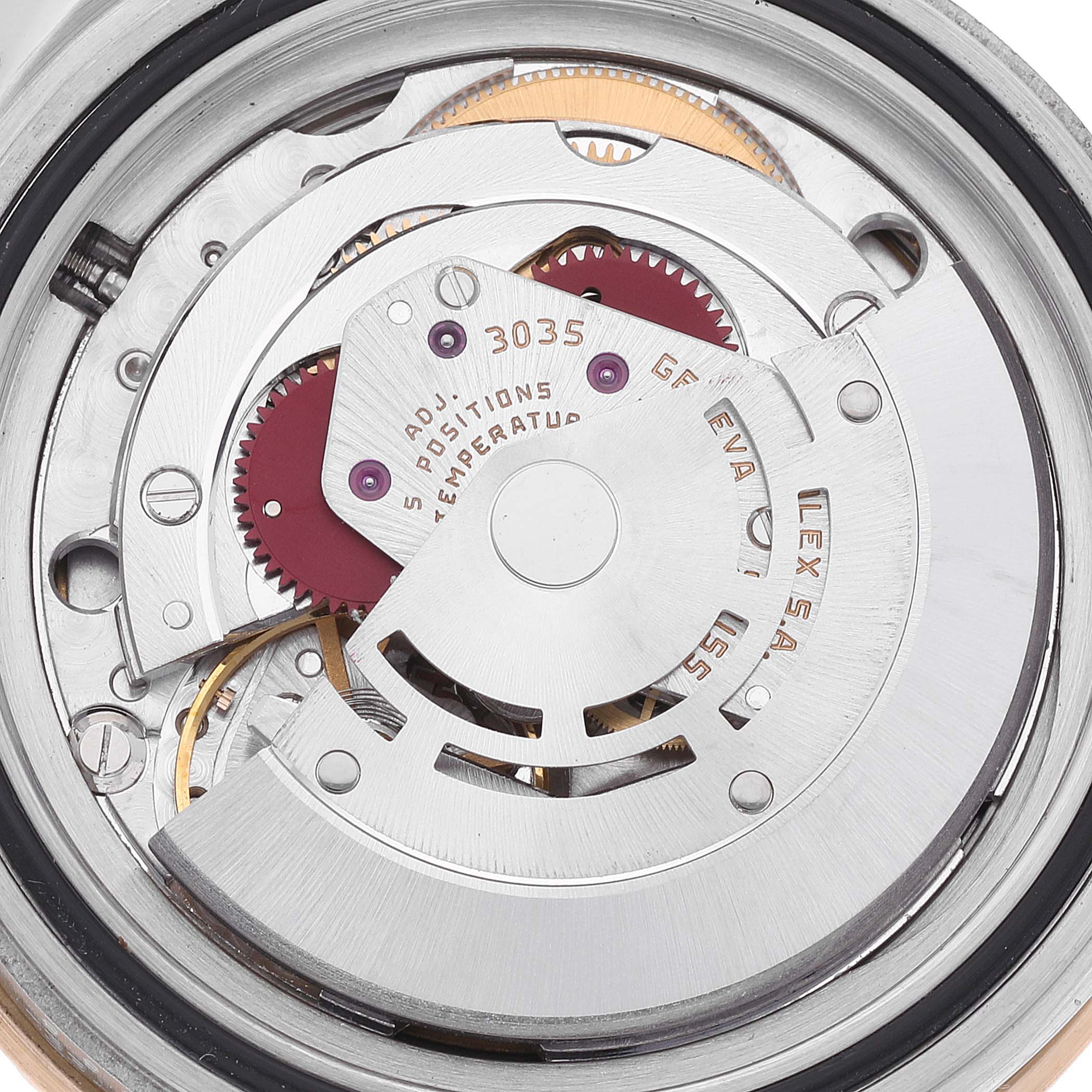 The image shows the intricate internal mechanism of a Rolex Submariner 16803 Men's Steel and Gold (two tone) Black Dial 16803 Men's Steel and Gold (two tone) Black Dial watch, including gears and the rotor.