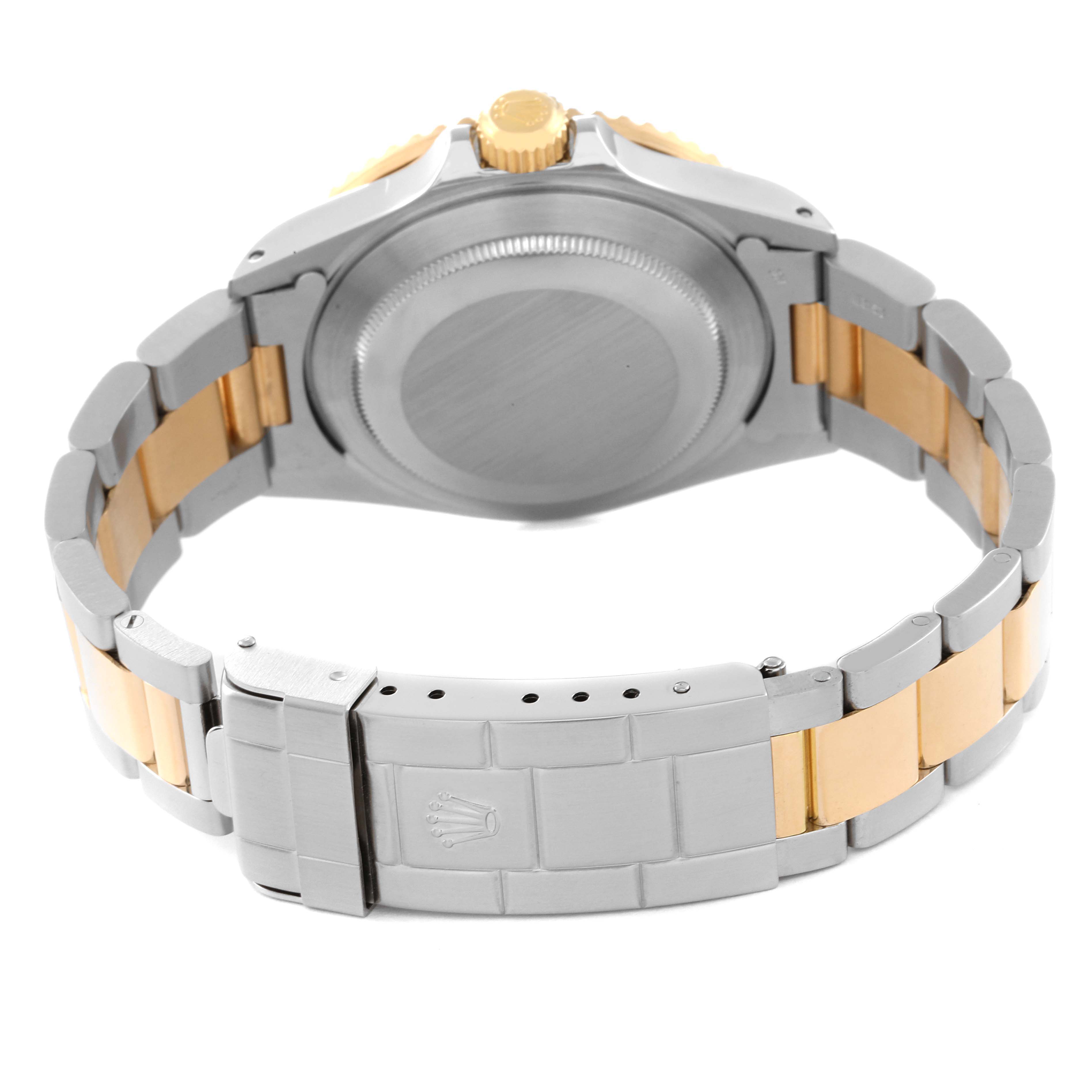 The image shows the back view of a Rolex Submariner 16803 Men's Steel and Gold (two tone) Black Dial 16803 Men's Steel and Gold (two tone) Black Dial, highlighting the case back, crown, and two-tone bracelet.