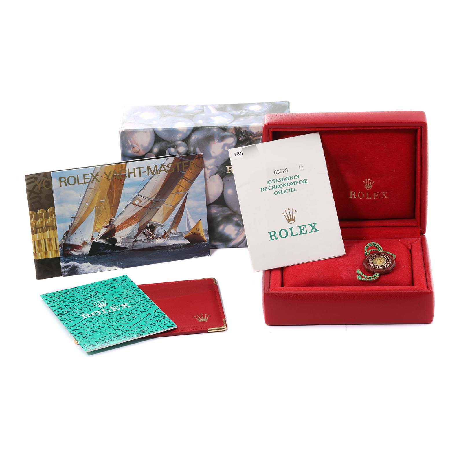 The image shows a Rolex Yacht-Master 69623 Women's Steel and Gold (two tone) White Dial 69623 Women's Steel and Gold (two tone) White Dial watch box, manuals, warranty card, and tags from an angled top view.