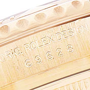 This close-up image shows the engraved side of a Rolex Yacht-Master 69628 Women's Yellow Gold White Dial 69628 Women's Yellow Gold White Dial watch casing.