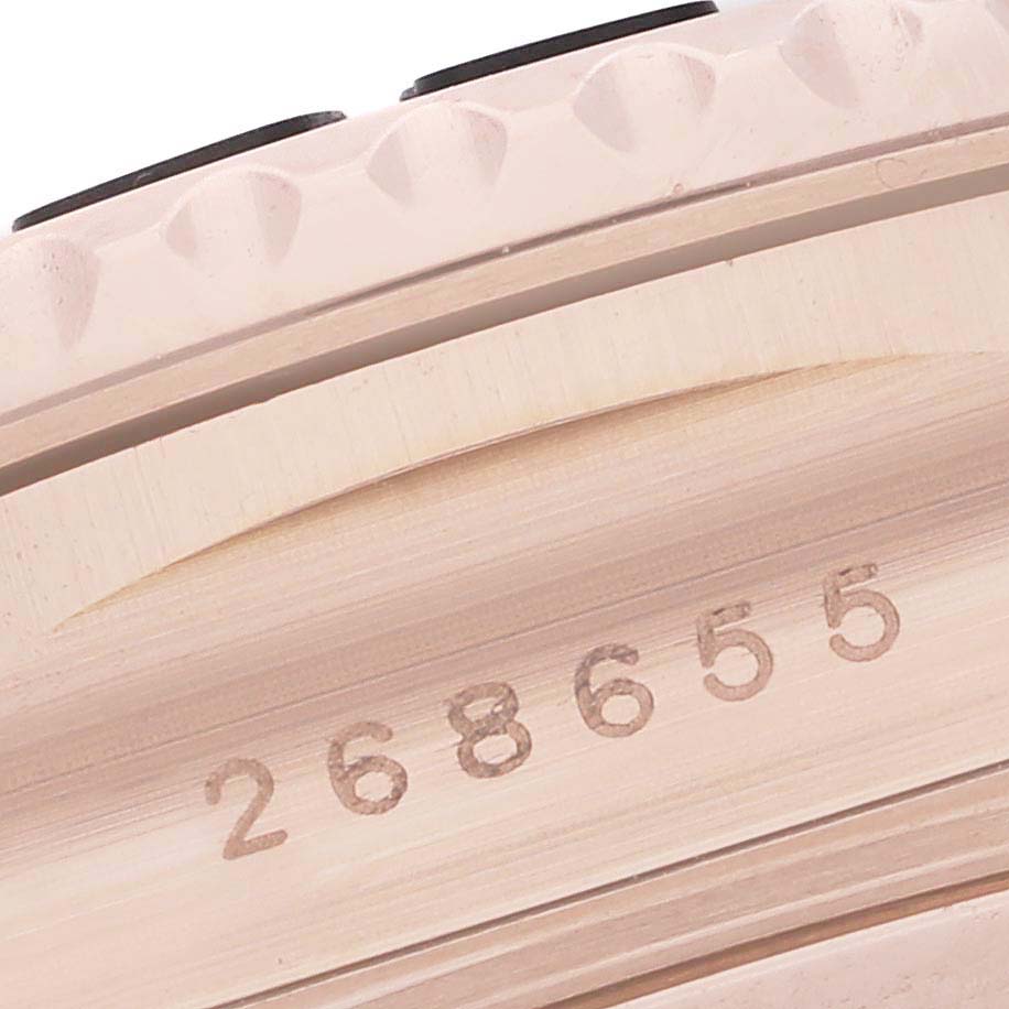 This close-up image shows the case side and part of the bezel of a Rolex Yacht-Master 268655 Men's Rose Gold Silver Dial 268655 Men's Rose Gold Silver Dial watch, including a serial number.