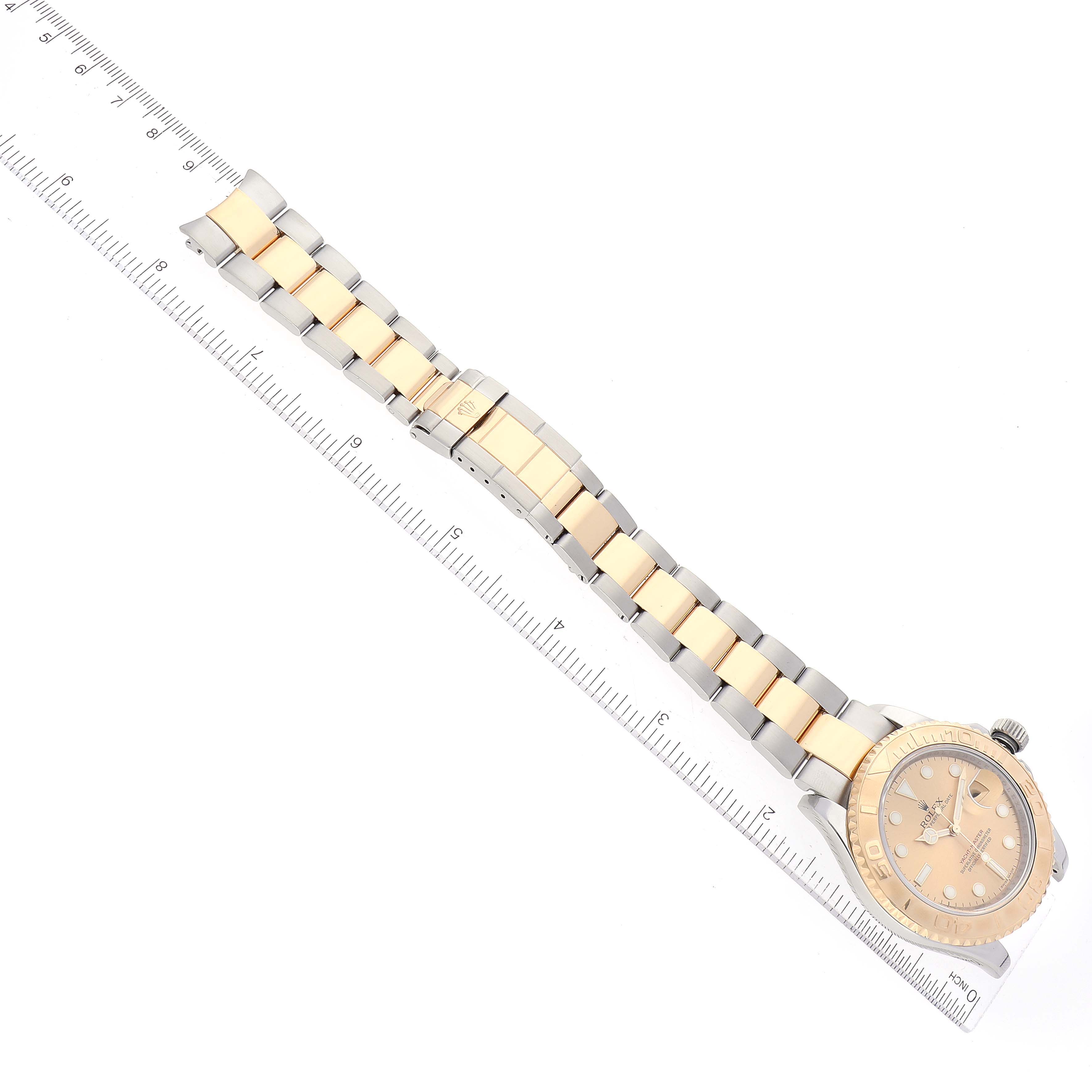The image shows a Rolex Yacht-Master 16623 Men's Steel and Gold (two tone) Champagne Dial 16623 Men's Steel and Gold (two tone) Champagne Dial watch laid flat alongside a ruler, displaying the full bracelet and watch face.