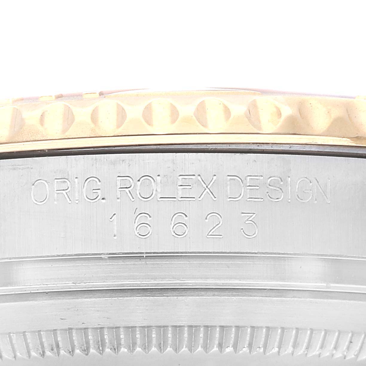 This image shows the side engraving and bezel of a Rolex Yacht-Master 16623 Men's Steel and Gold (two tone) Champagne Dial 16623 Men's Steel and Gold (two tone) Champagne Dial model, design number 16623.