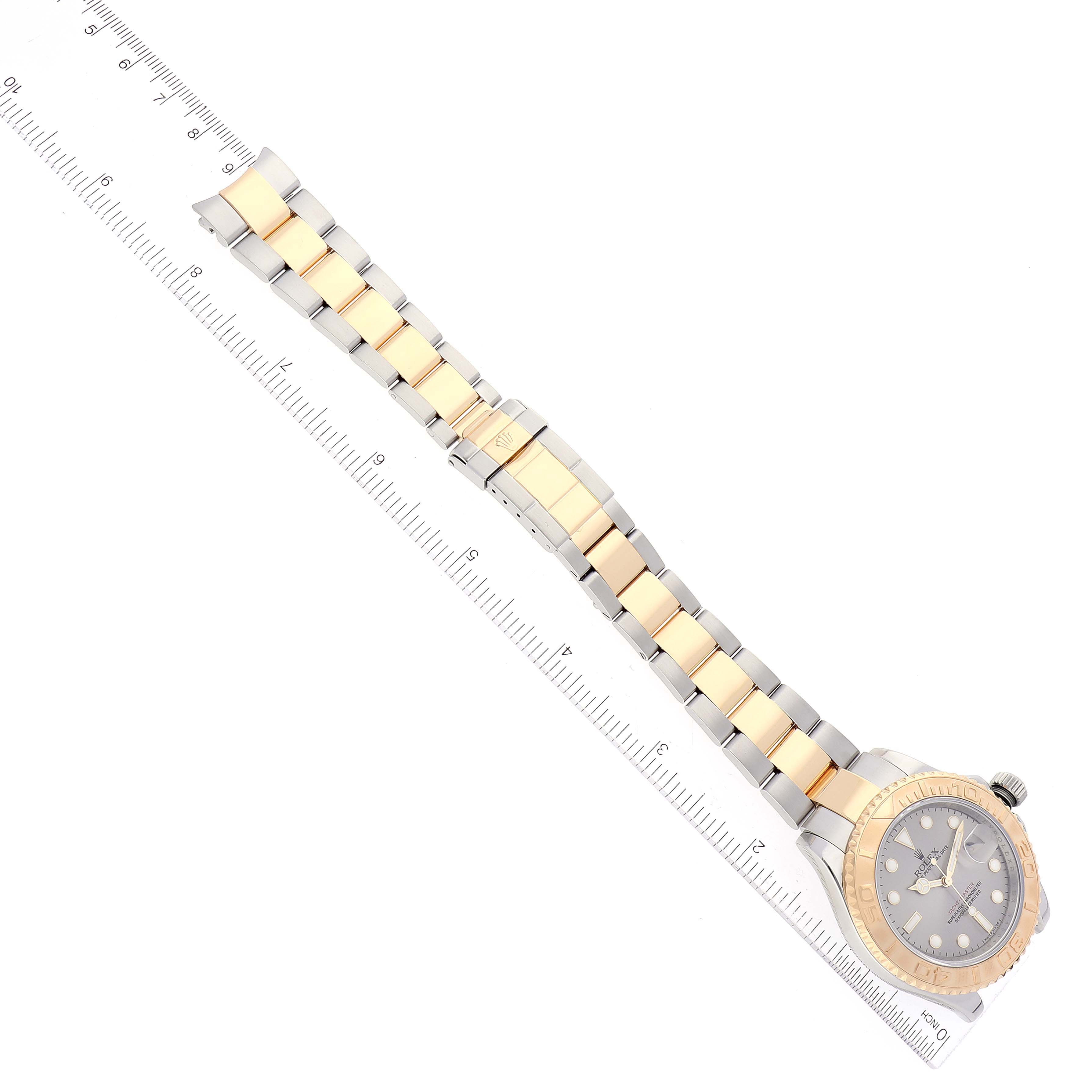 The image shows a Rolex Yacht-Master 16623 Men's Steel and Gold (two tone) Grey Dial 16623 Men's Steel and Gold (two tone) Grey Dial watch laid flat next to a ruler, displaying its band and face from a top-down angle.