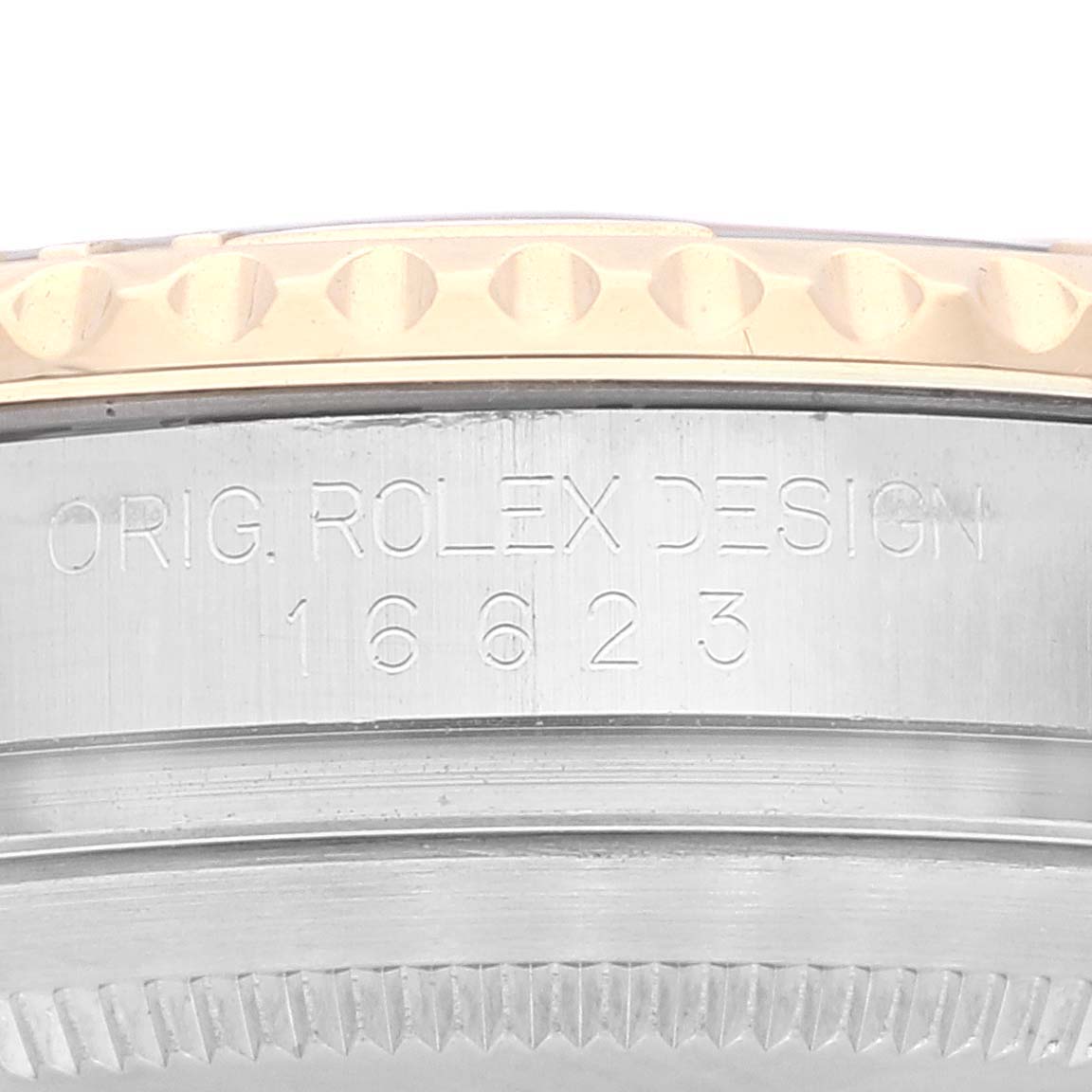 The image shows a close-up angle of the Yacht-Master model by Rolex, highlighting its bezel and engraved serial number.