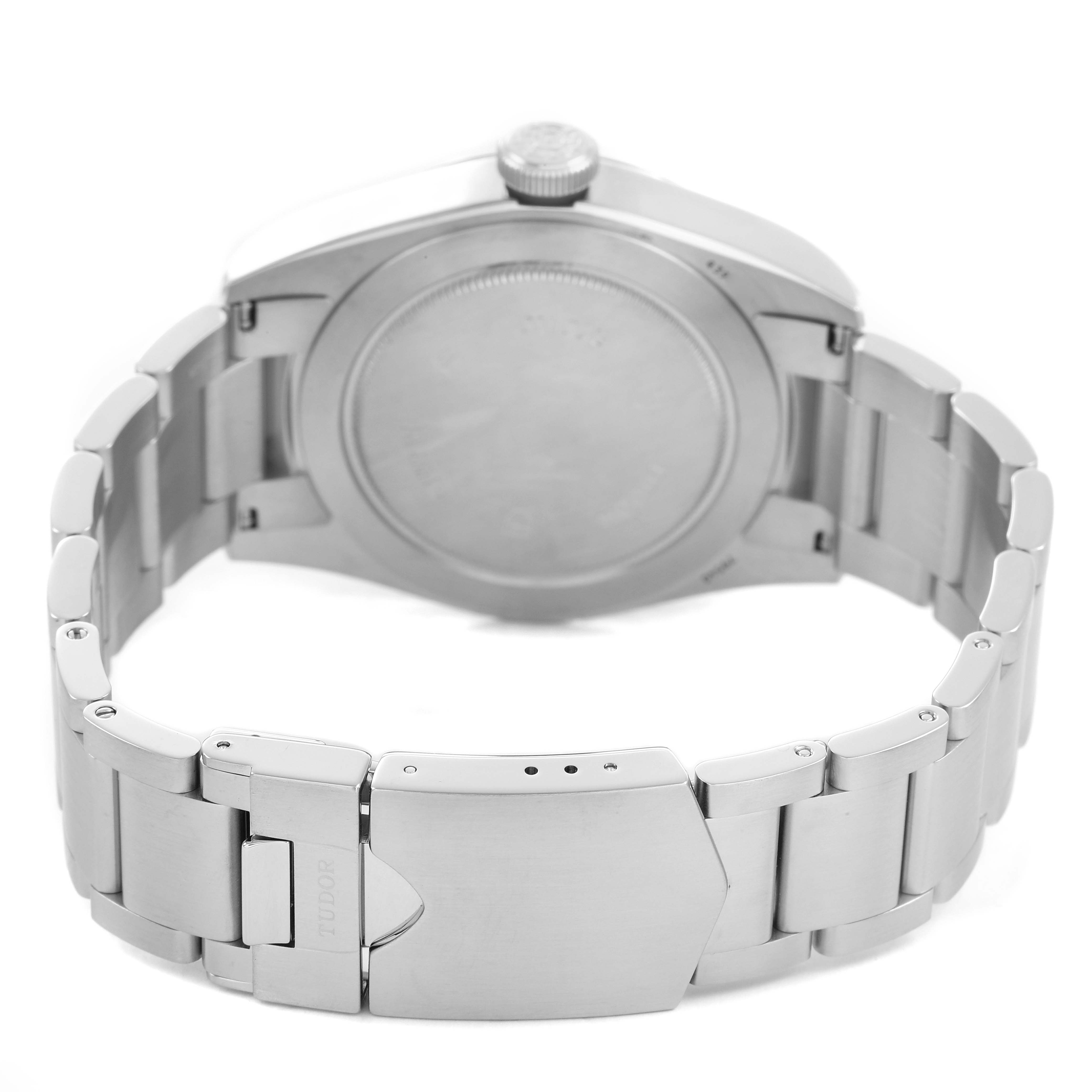 The Tudor Heritage Black Bay M79540 Men's Stainless Steel Silver Dial watch is shown from the back, highlighting the case back and metal bracelet with clasp.