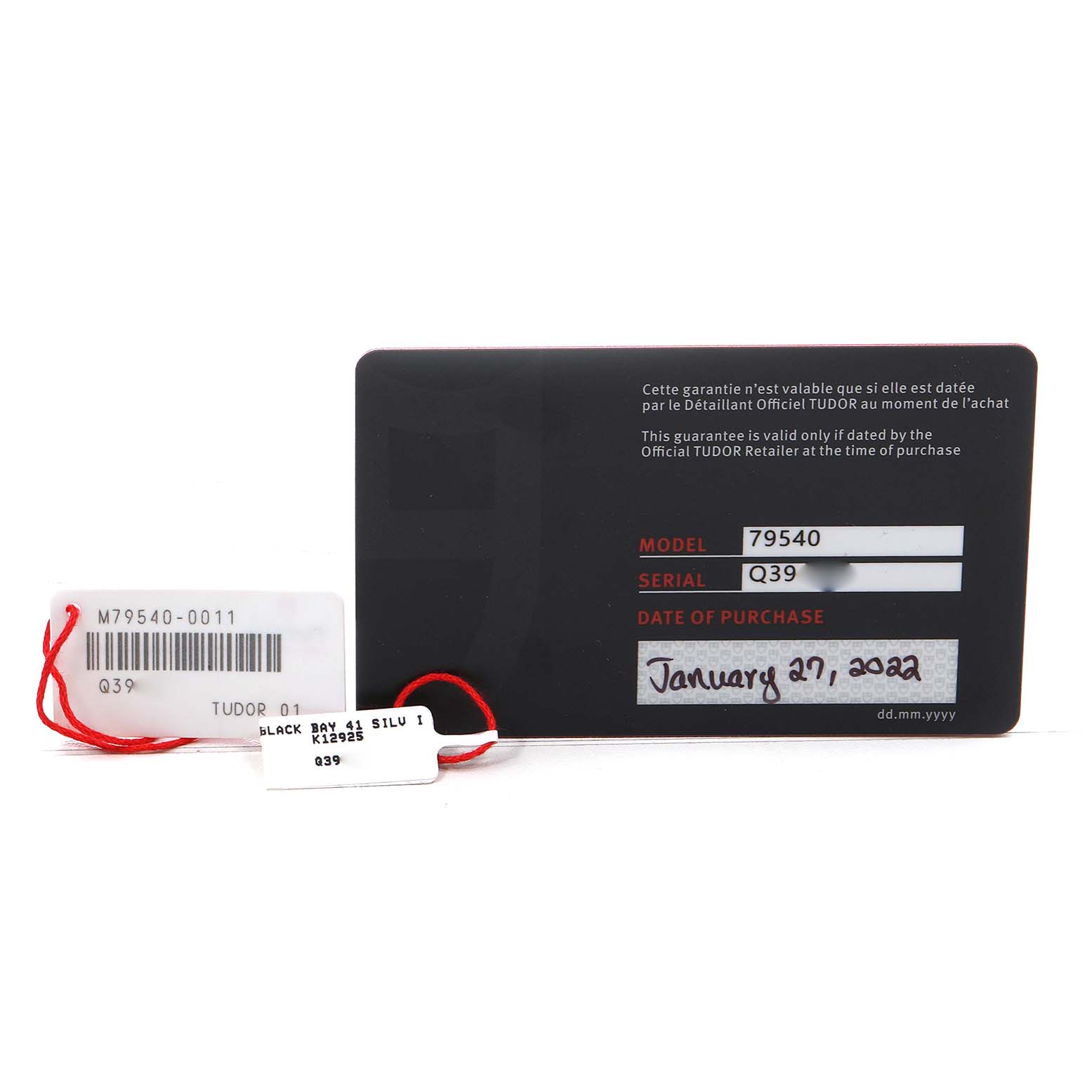 The image shows warranty cards and tags for a Tudor Heritage Black Bay M79540 Men's Stainless Steel Silver Dial watch, displaying model and serial numbers.