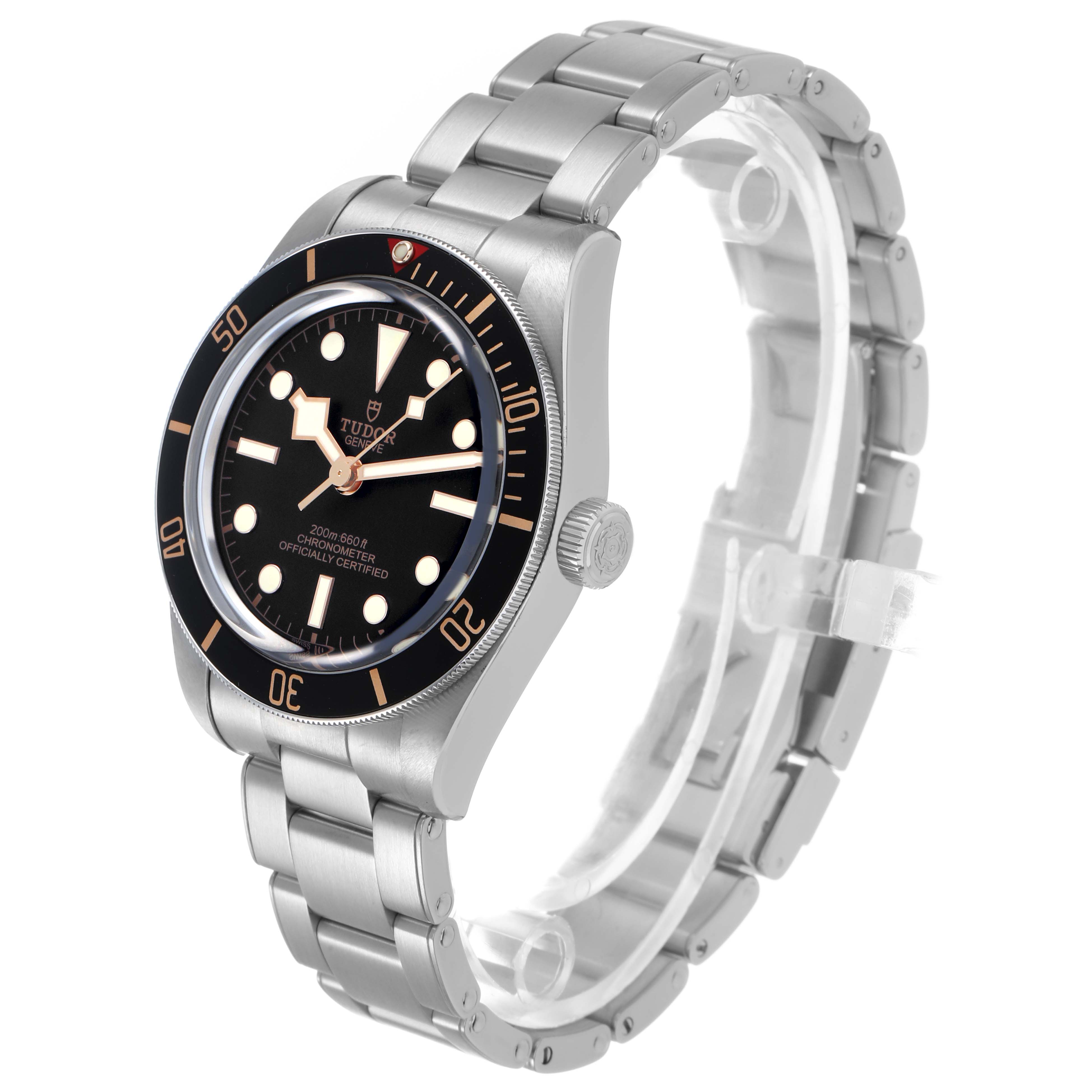 The Tudor Heritage Black Bay 79030 Men's Stainless Steel Black Dial watch is shown at a three-quarter angle, displaying the dial, bezel, crown, and metal bracelet.