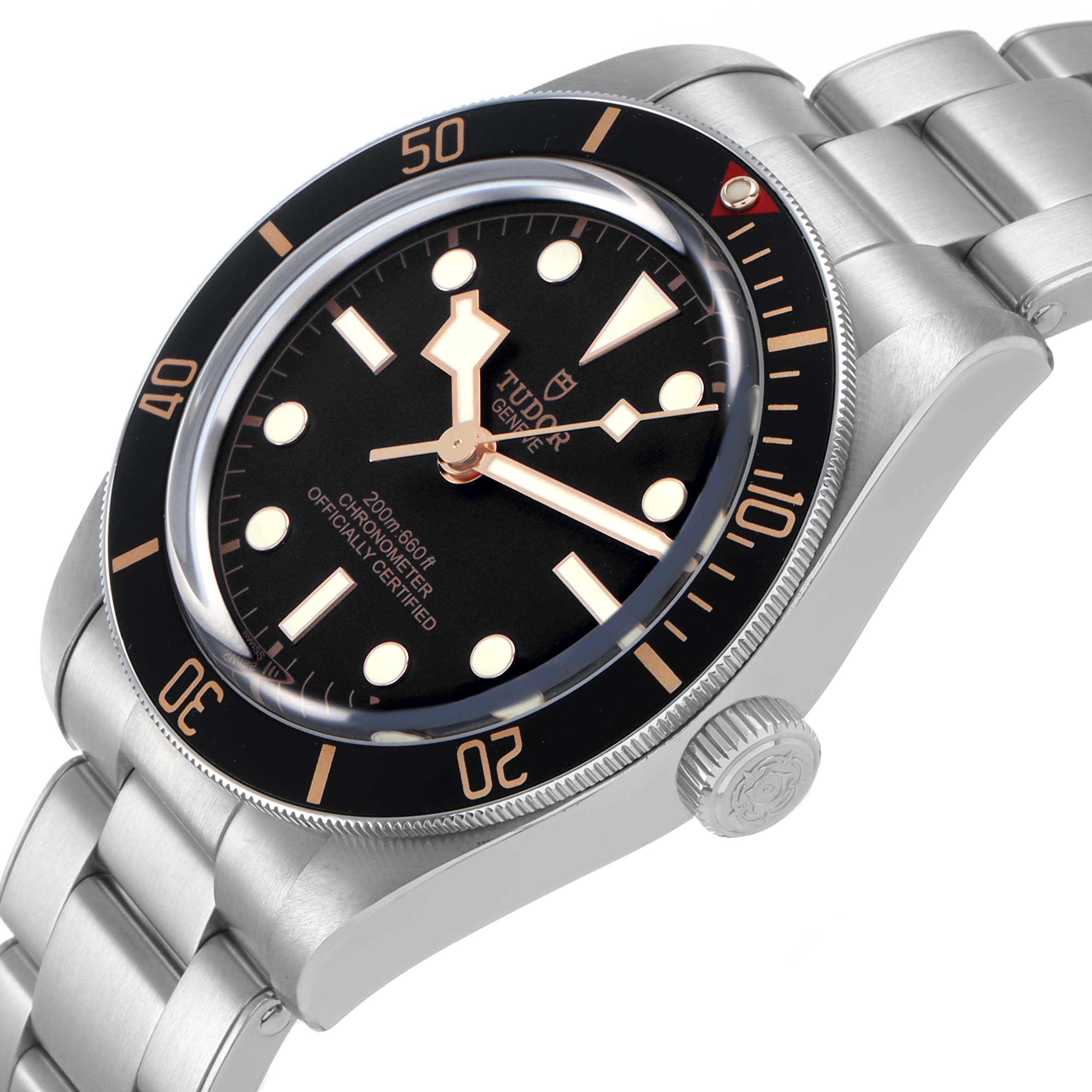 The Tudor Heritage Black Bay 79030 Men's Stainless Steel Black Dial watch is shown at a slight angle, highlighting the dial, bezel, crown, and metal bracelet.