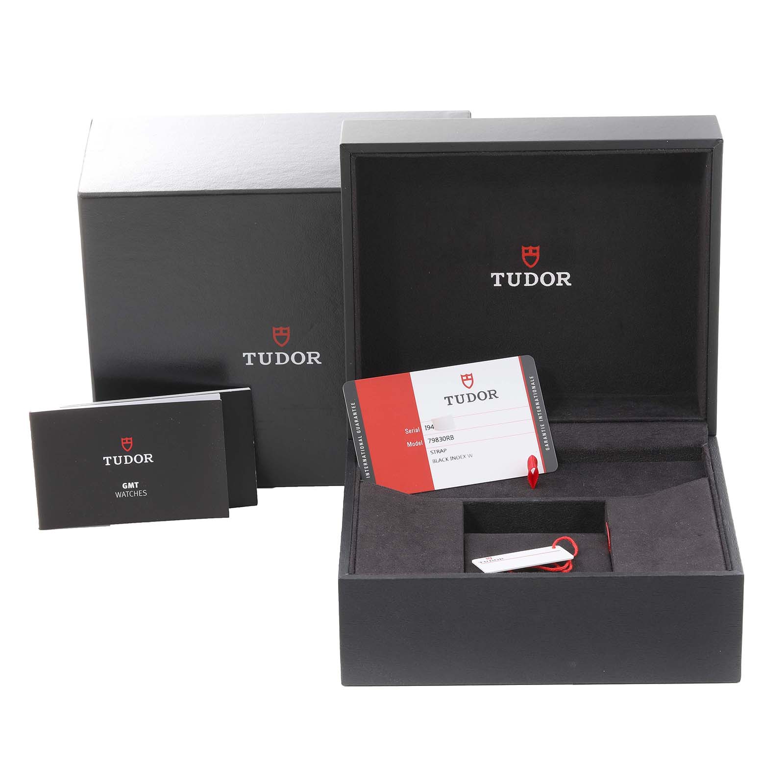 The image shows the Tudor Heritage Black Bay 79830RB Men
s Stainless Steel Black Dial 79830RB Men
s Stainless Steel Black Dial watch box set, with an open box, papers, and a warranty card displayed.