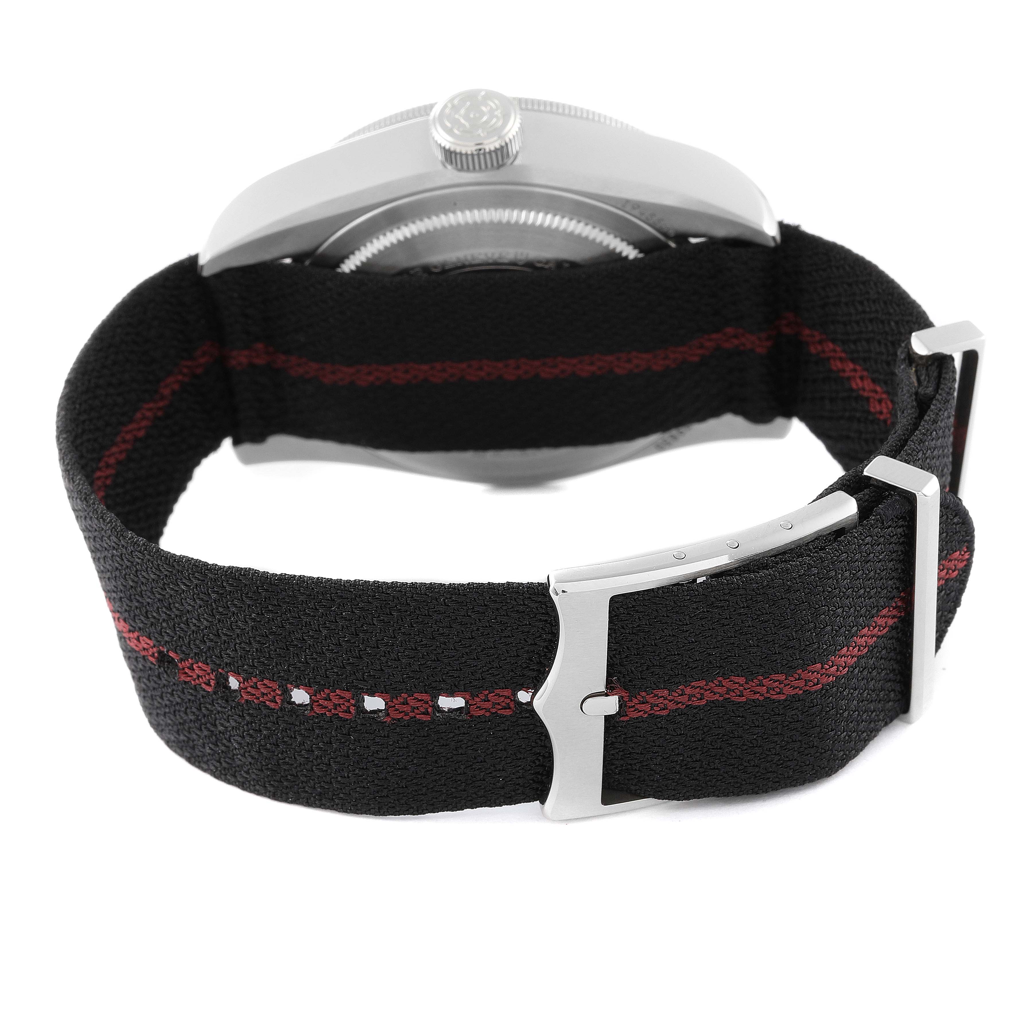 This image shows the rear view of a Tudor Heritage Black Bay 79830RB Men
s Stainless Steel Black Dial 79830RB Men
s Stainless Steel Black Dial watch, focusing on its black fabric strap with red stitching and clasp.
