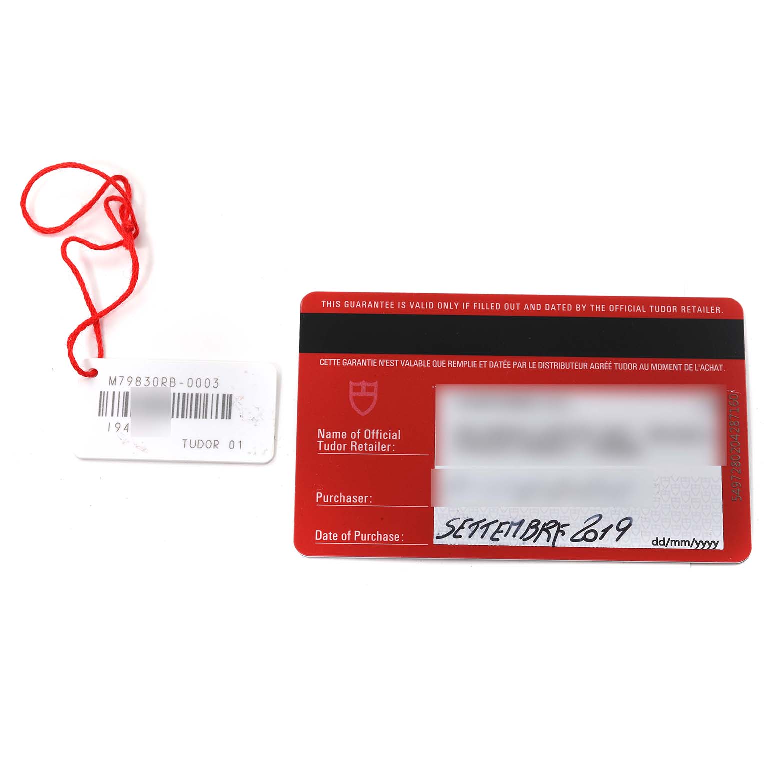 The image shows the warranty card and tag for a Tudor Heritage Black Bay 79830RB Men
s Stainless Steel Black Dial 79830RB Men
s Stainless Steel Black Dial watch.