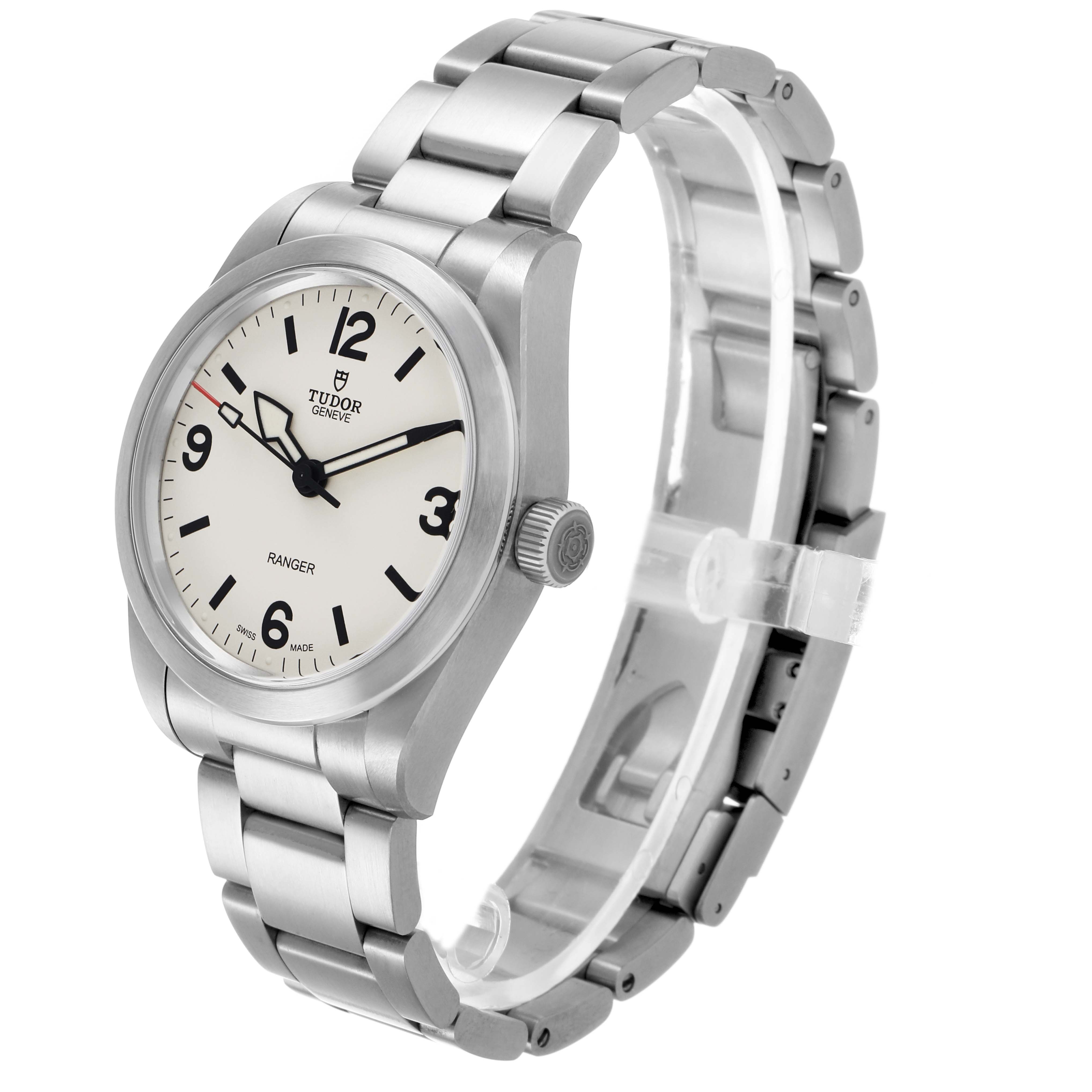 The Tudor Heritage Ranger 79930 Men's Stainless Steel Beige Dial watch is shown at a three-quarter angle, highlighting the dial, case, crown, and stainless steel bracelet.