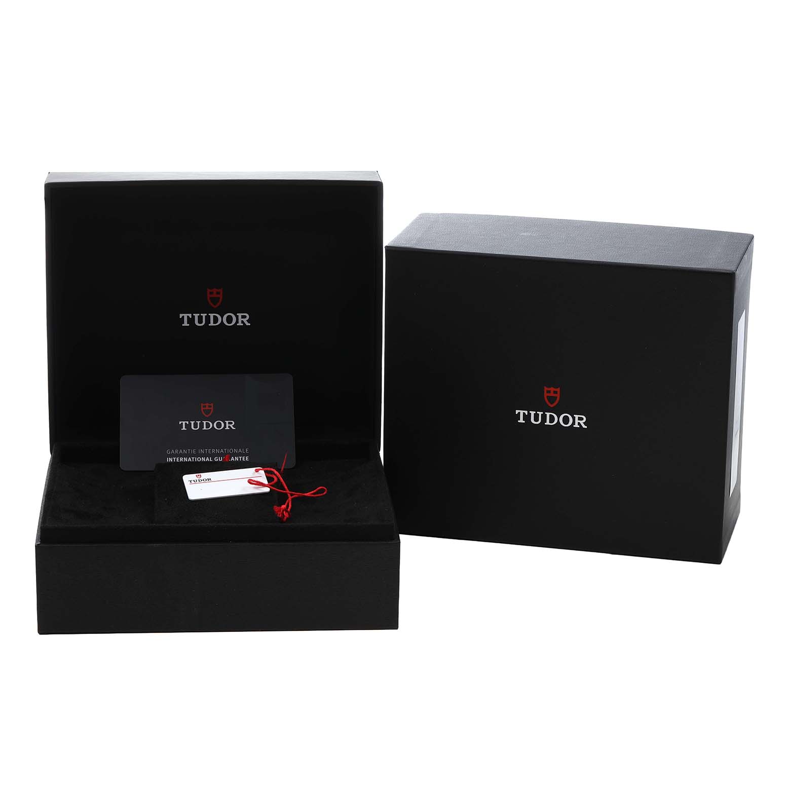The image shows the packaging for a Tudor Heritage Ranger 79930 Men's Stainless Steel Beige Dial watch, including a box, guarantee card, and tag.