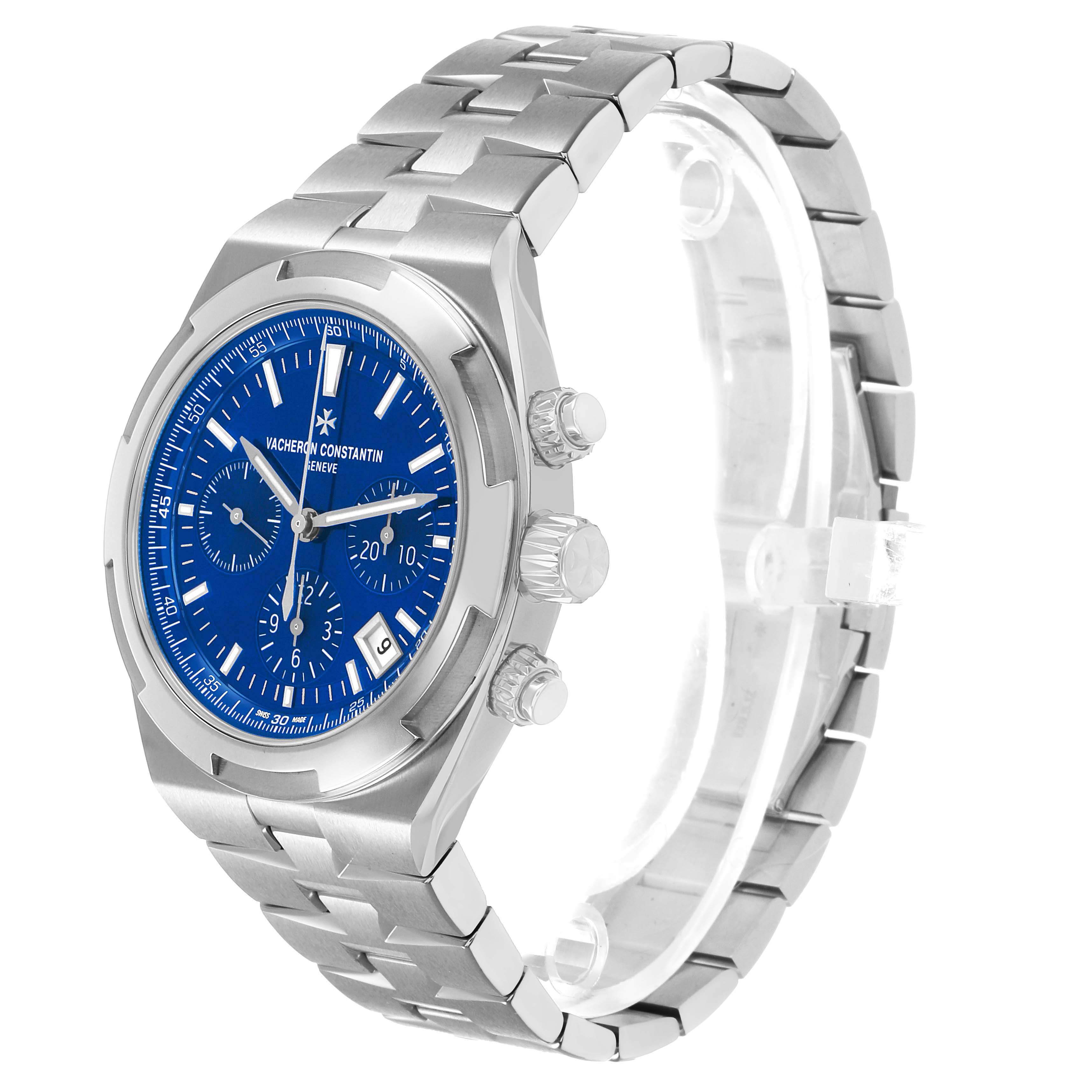 The Vacheron Constantin Overseas 5520V Men's Stainless Steel Blue Dial watch is shown at a 3/4 angle, displaying the dial, bezel, crown, pushers, and bracelet.