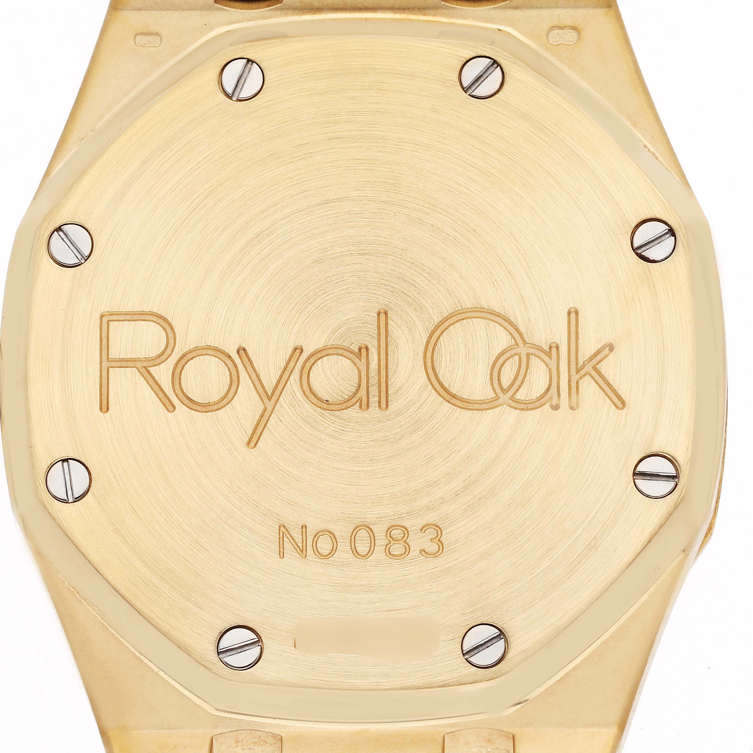 The image shows a close-up of the engraved gold case back of the Audemars Piguet Royal Oak 25730BA Men
s Yellow Gold Beige Dial 25730BA Men
s Yellow Gold Beige Dial watch.