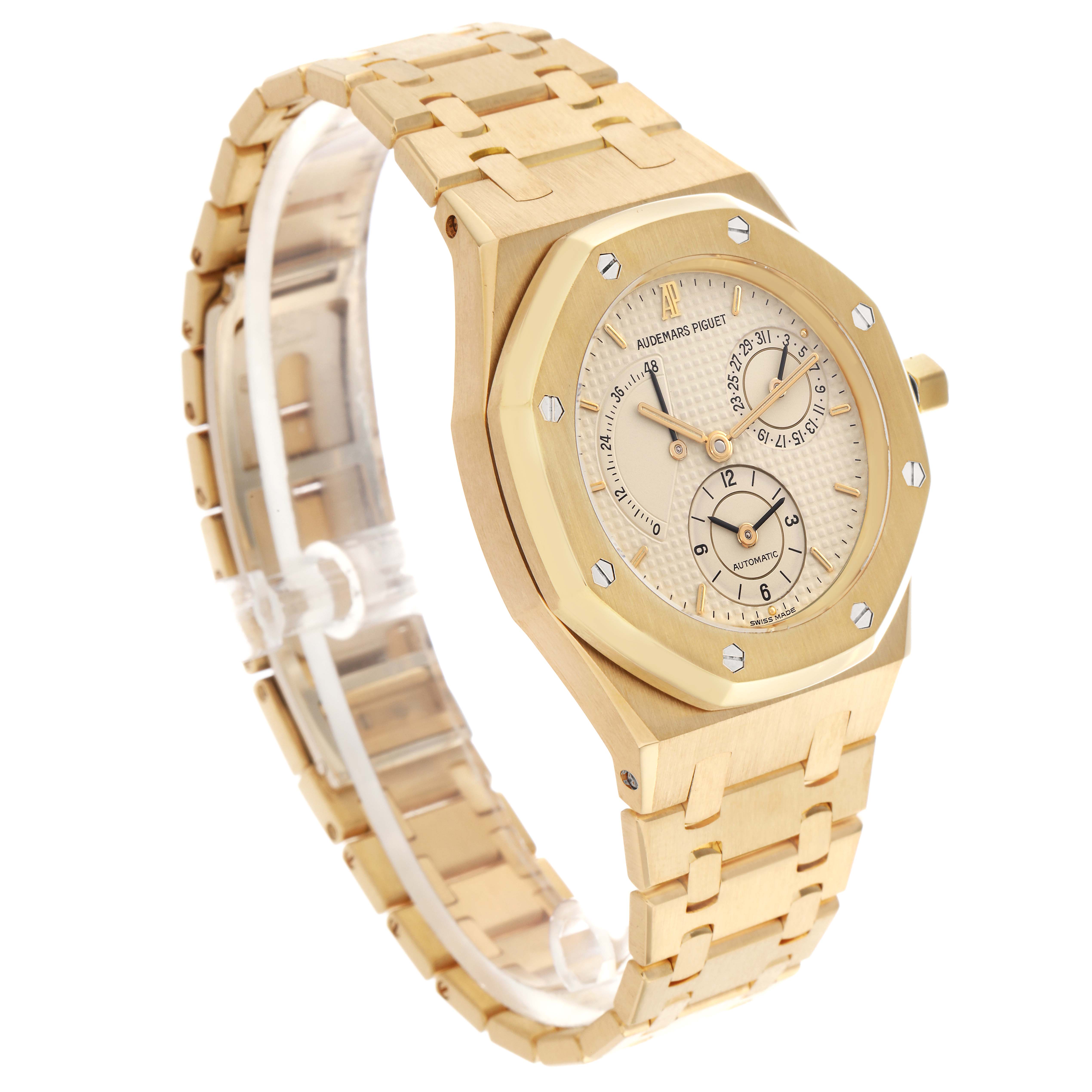 The Audemars Piguet Royal Oak 25730BA Men
s Yellow Gold Beige Dial 25730BA Men
s Yellow Gold Beige Dial watch is shown at a three-quarter angle, highlighting its face, bezel, and bracelet.