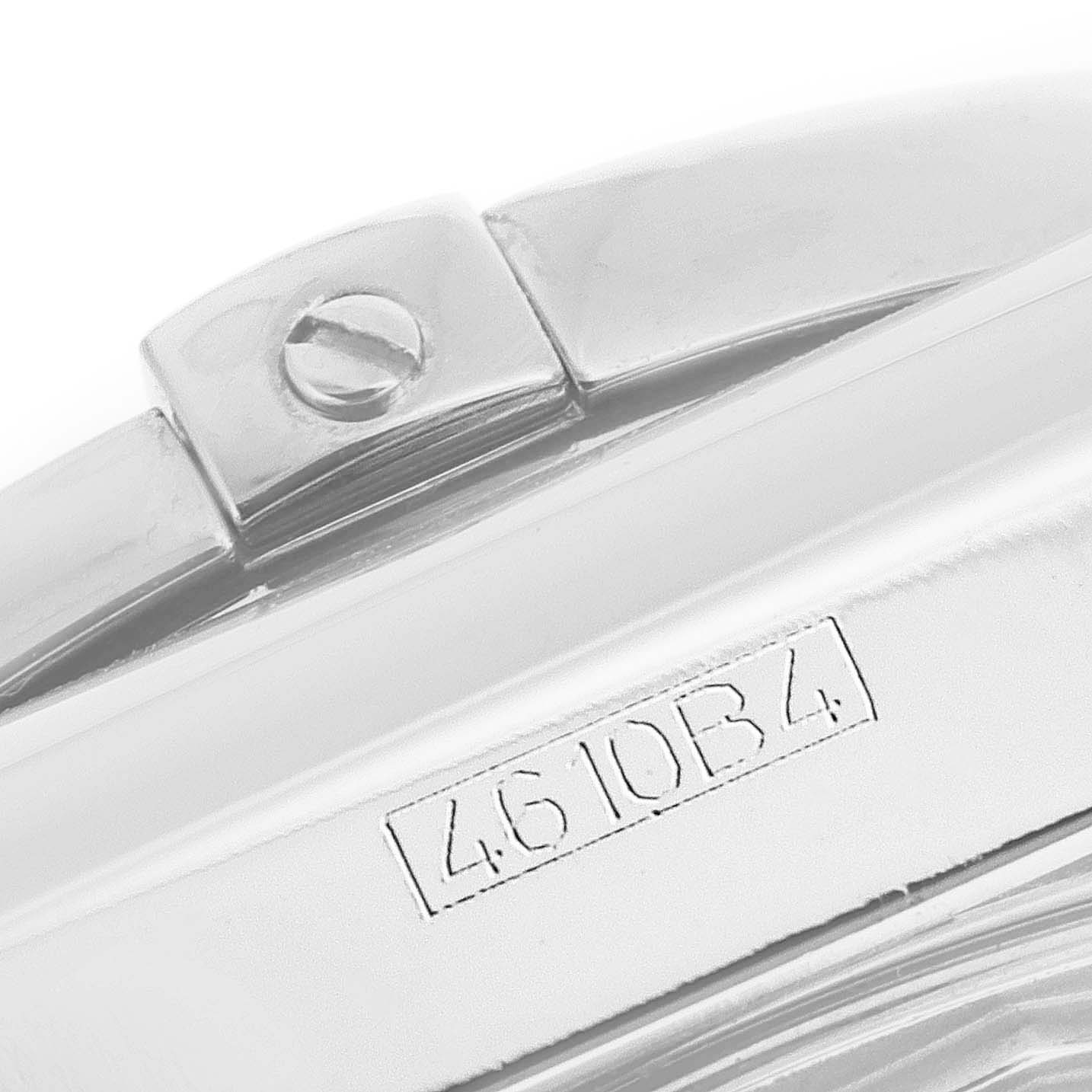 This image shows a close-up of the metal clasp on a Breitling Chronomat AB0110 Men's Stainless Steel White Dial AB0110 Men's Stainless Steel White Dial watch bracelet, with an engraved serial number.